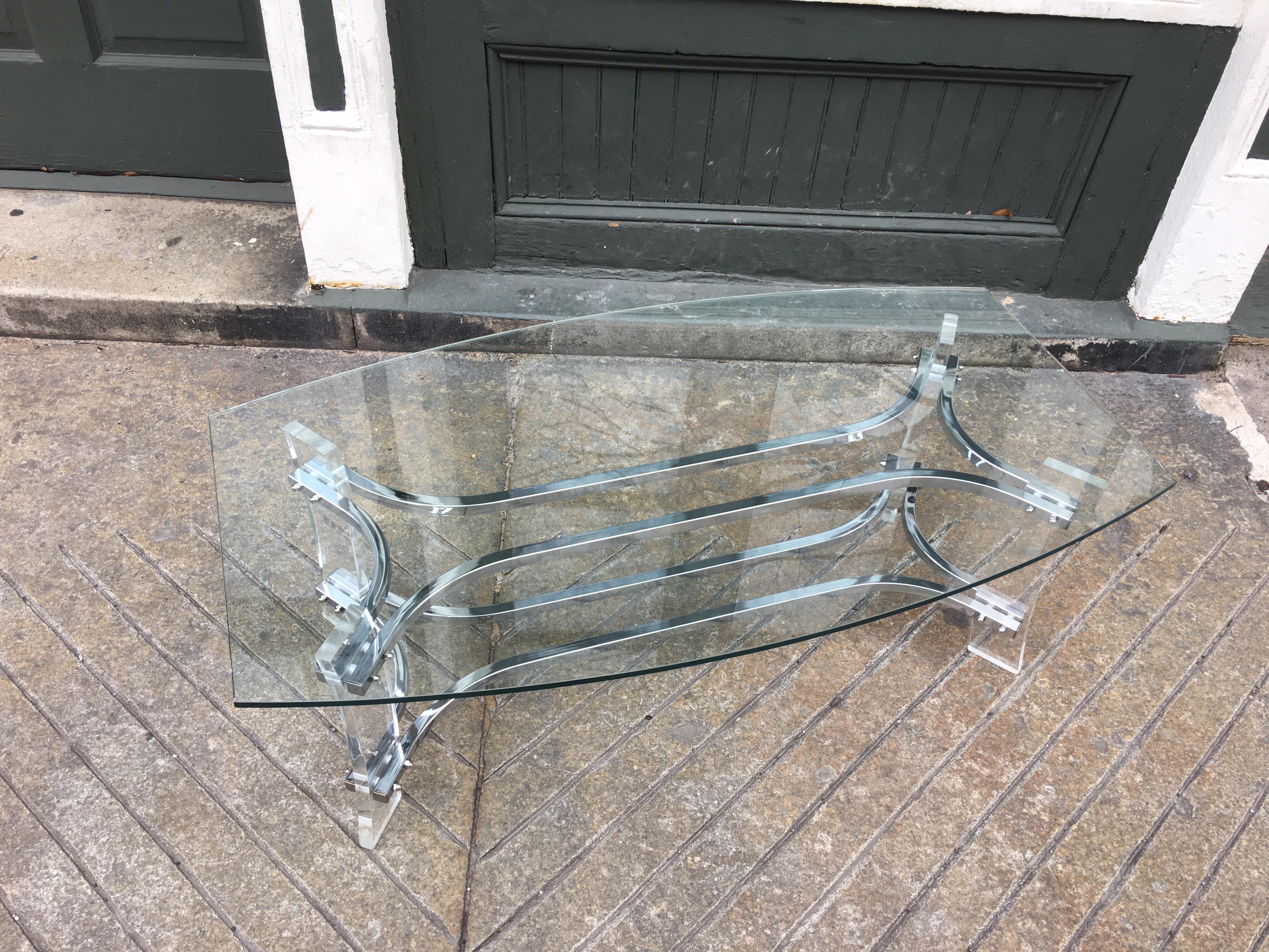 American glass, Lucite and chrome coffee table. Glass top has ends that taper in a bit to give this table a unique look! Chrome is in amazing clean condition! Lucite has been polished and presents very well!