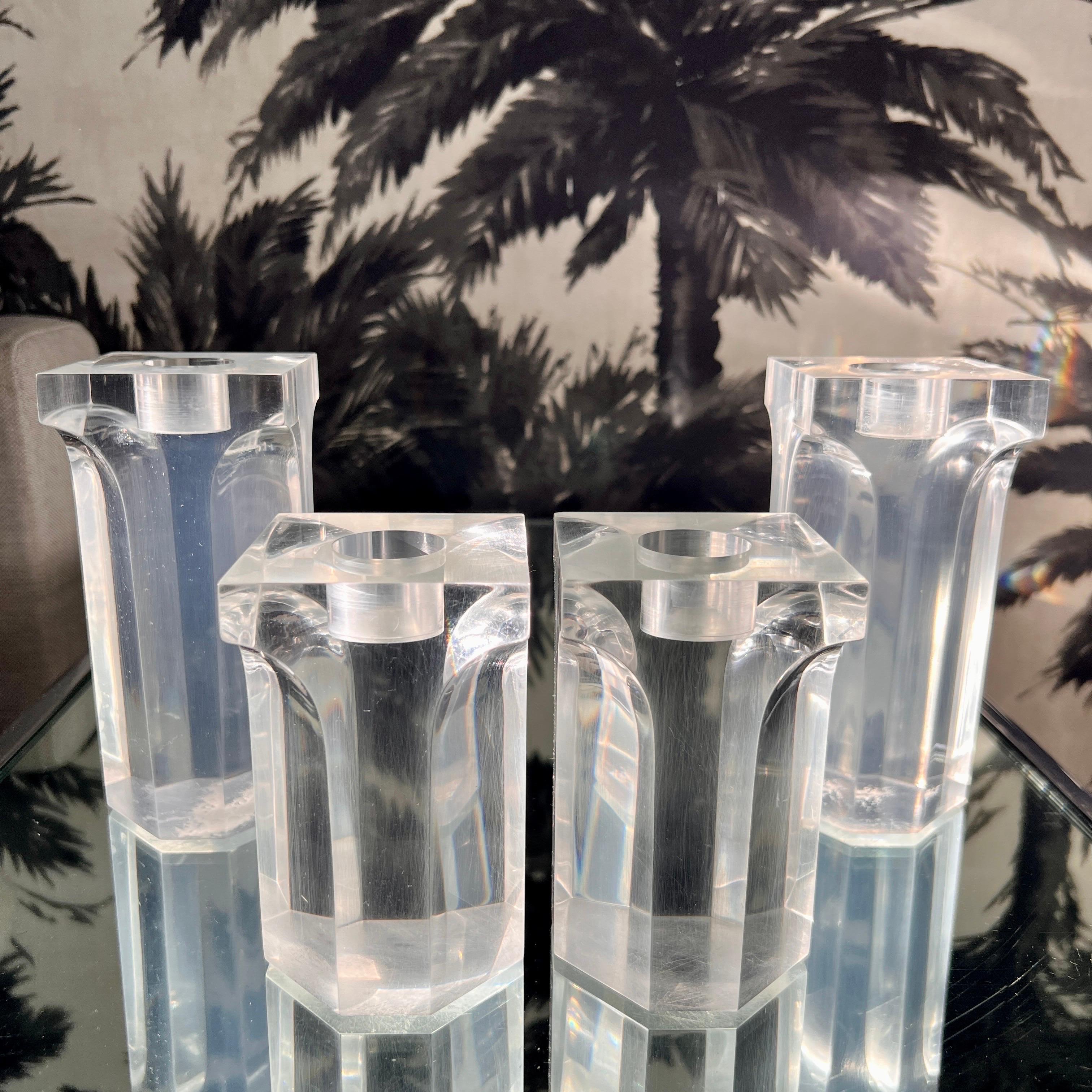 Mid-Century Modern candleholders in the style of Charles Hollis Jones with architectural Corinthian column design. Handcrafted of solid lucite with polished edges and beveled details. The set includes two taller candle holders at 6.25