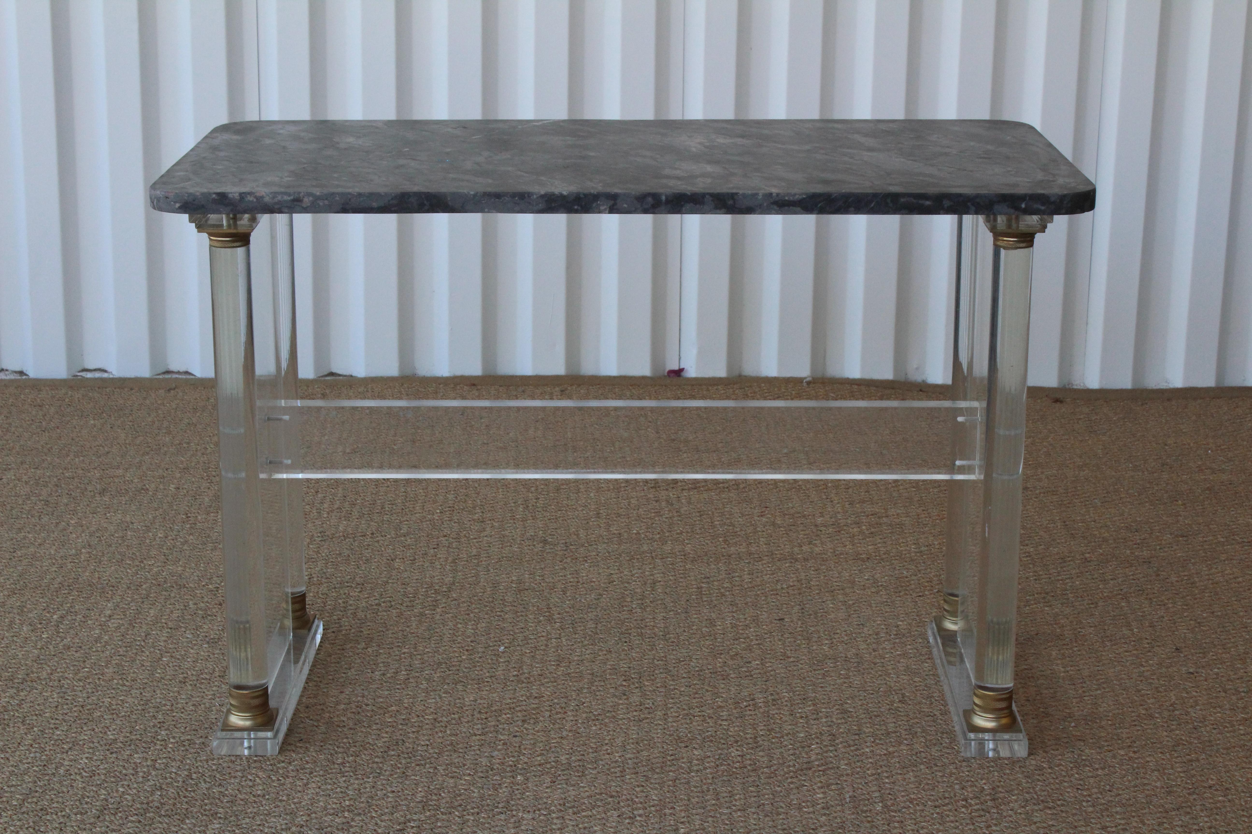 1970s Lucite console with brass accents, fitted with an antique marble top. Lucite base is in good condition with minor wear. Antique marble top has been custom cut and honed.