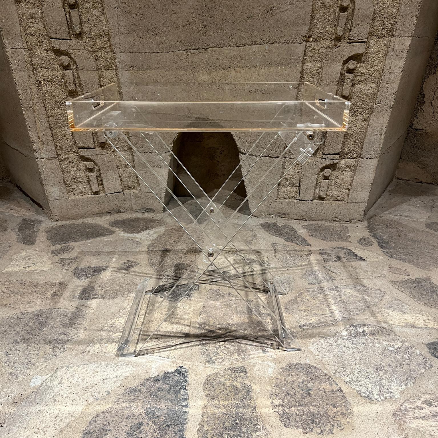 AMBIANIC presents
1970s Lucite Folding Service TV Tray Table
22.25 h x 15 d x 19 w folded 27.5 h x 3.5 x 15 w
Preowned vintage condition
Refer to images provided.