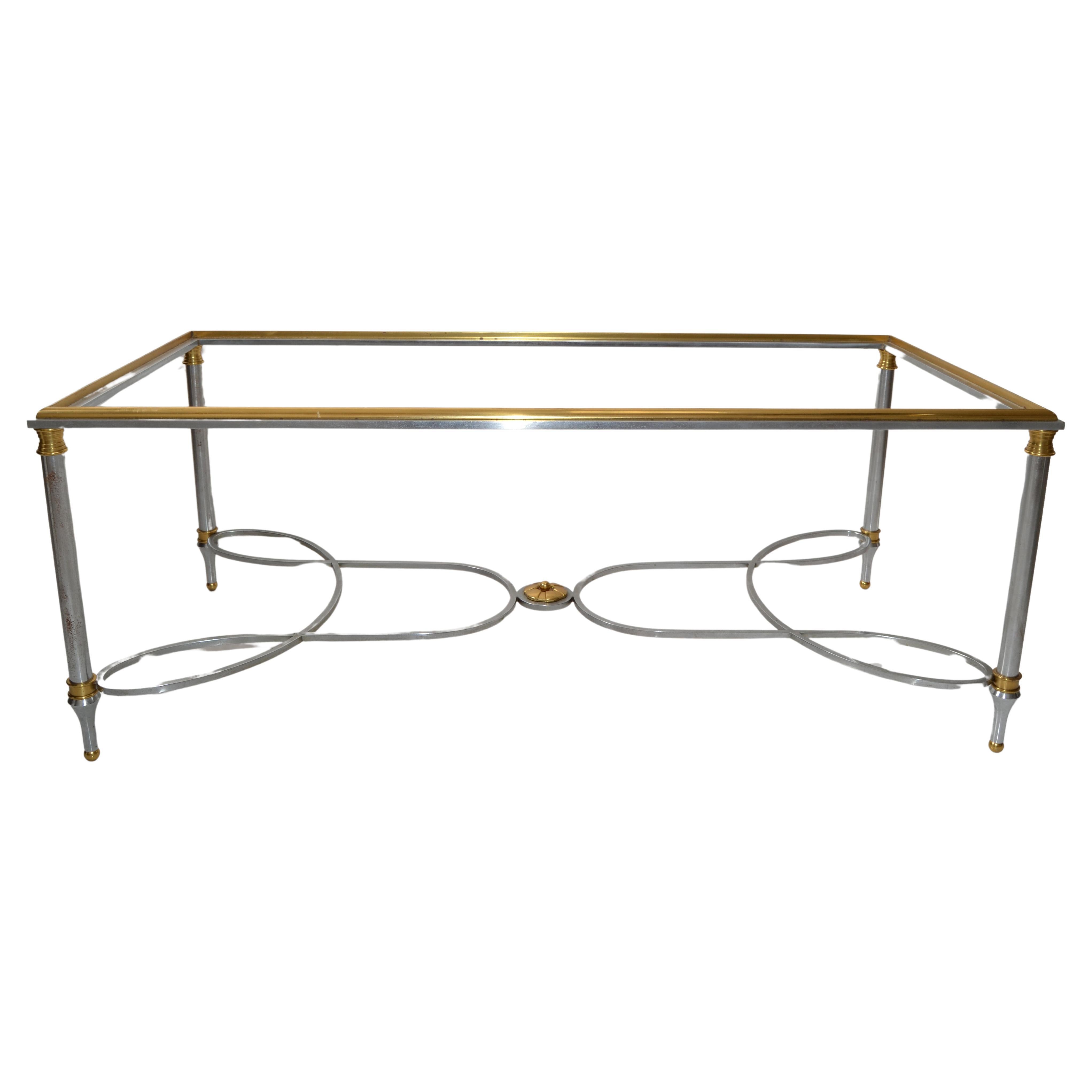 Mid-Century Modern Artisan French rectangle Coffee Table made of chromed steel, steel, brass and topped with an inserted clear Glass Shelf.
Crafted by iconic Parisian Workshop / Studio Maison Charles. 
In good condition, polished and Glass made