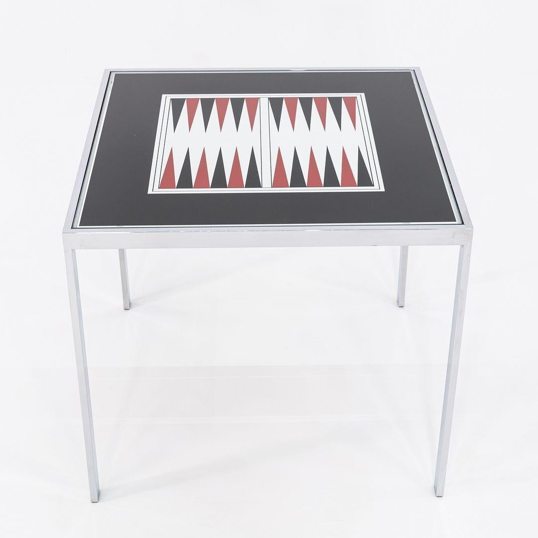 Il s'agit d'une table de jeu de backgammon / table à manger qui a été produite par la Maison Jansen en France. Cet exemple particulier date des années 1970. La table est composée d'un cadre en acier et d'un plateau en verre. 
 
 La table mesure