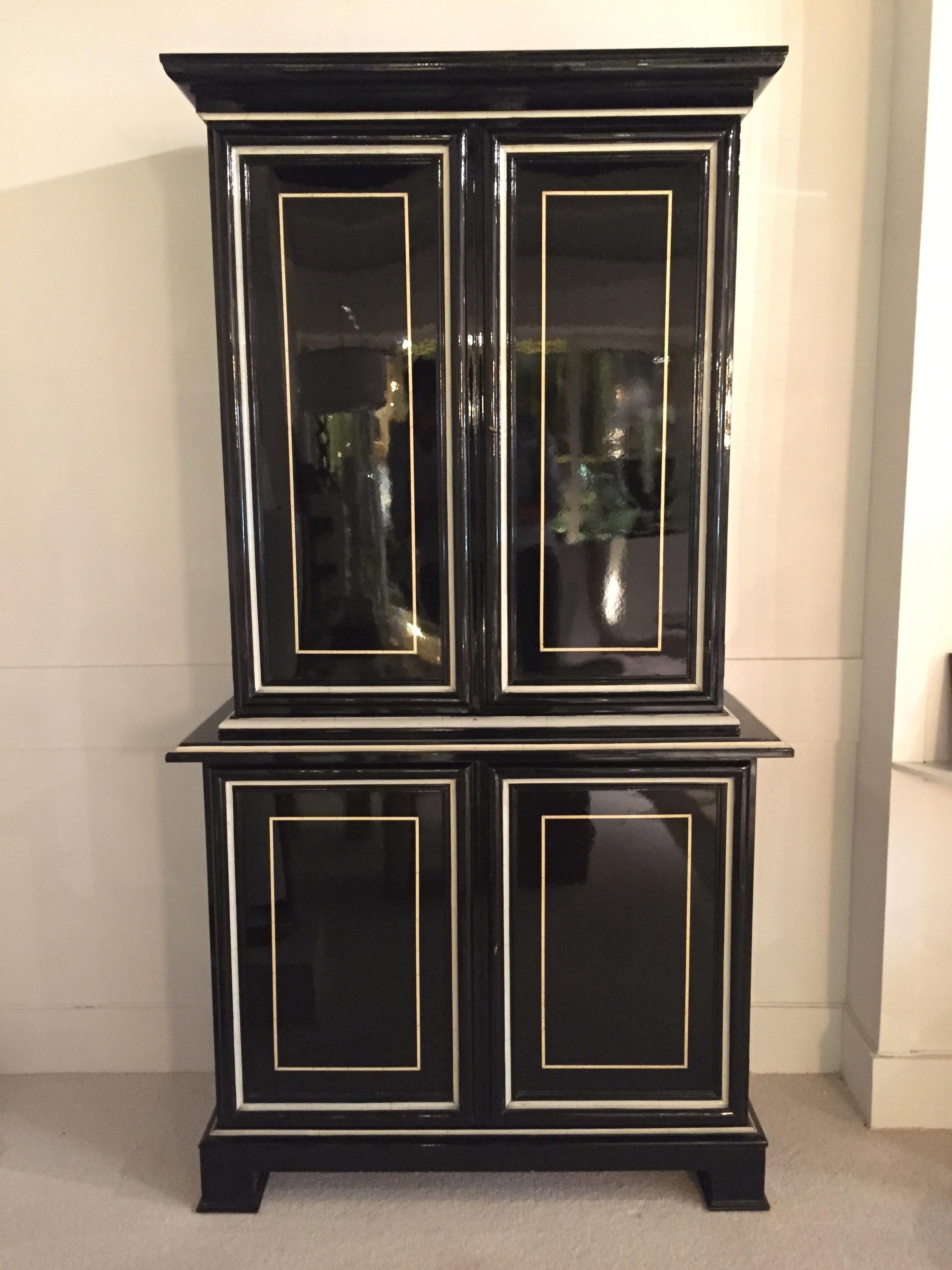 Black and faux ivory lacquered Trumeau by Maison Jansen.
Mirrored Interior on the top doors.
Can be found on Maison Jansen Book by Archers Abbot.
Great condition for the lacquer.