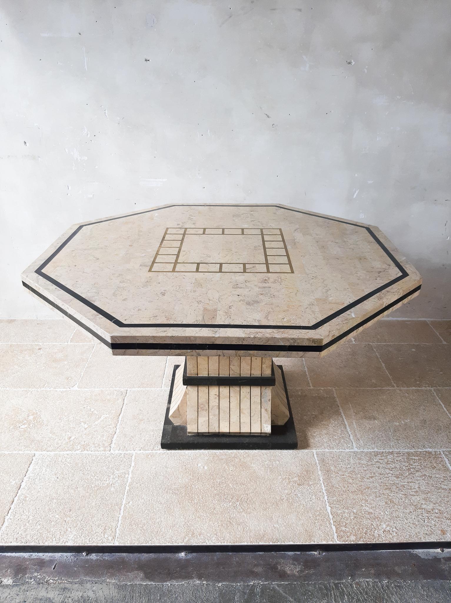 Maitland Smith tessalated marble dining table. Midcentury, vintage dining table from the 70s by maitland Smith. This Miami Vice style hectagonal diningtable is made from tesselated marble and in the top and in the base laid in with brass. The