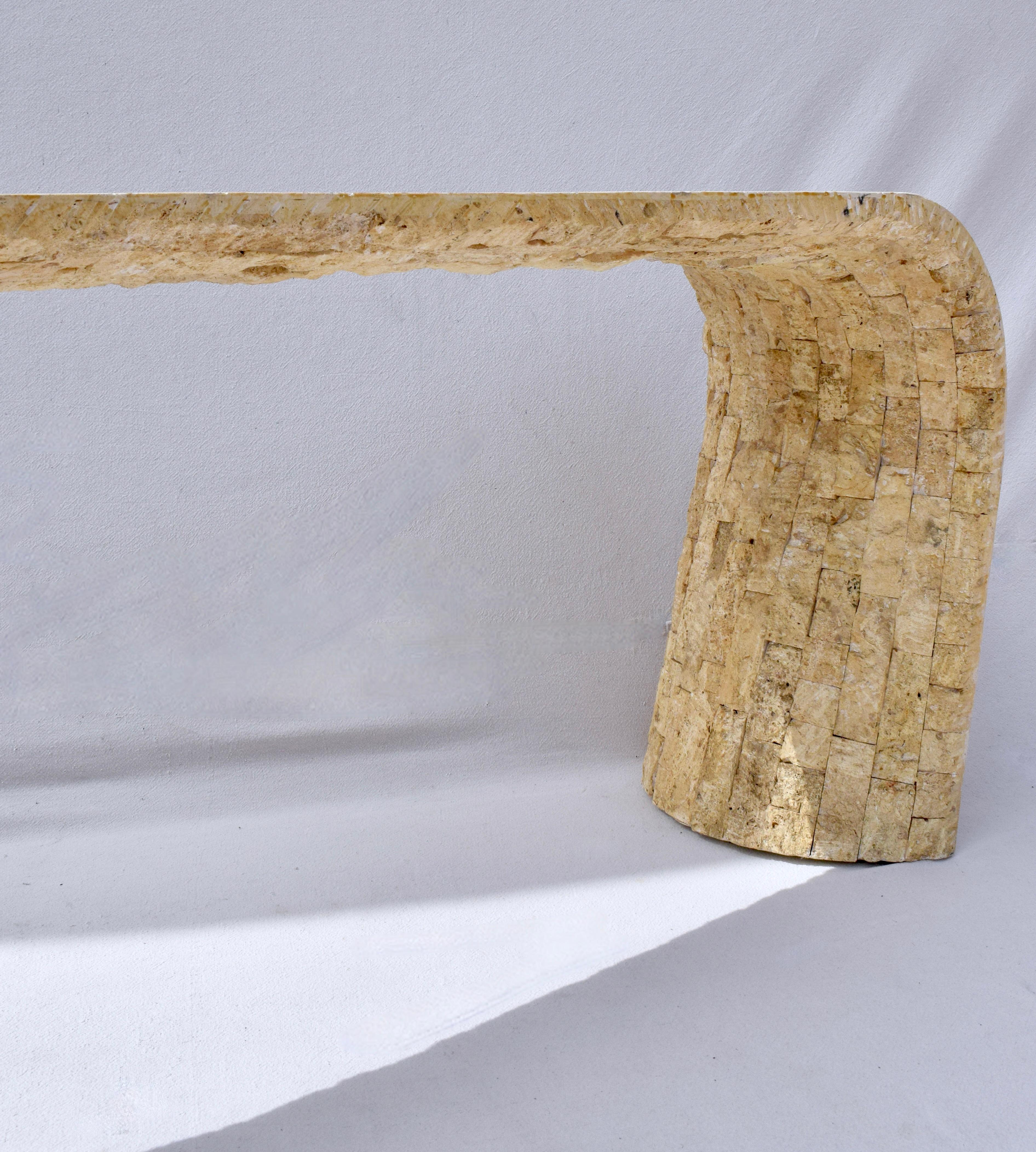 Striking Mediterranean style tessellated stone console table, circa 1970s constructed of fossilized design of both rough-hewn and smooth surfaces. Our photo shoot took place during the 2024 solar eclipse. The changing light at the time perfectly