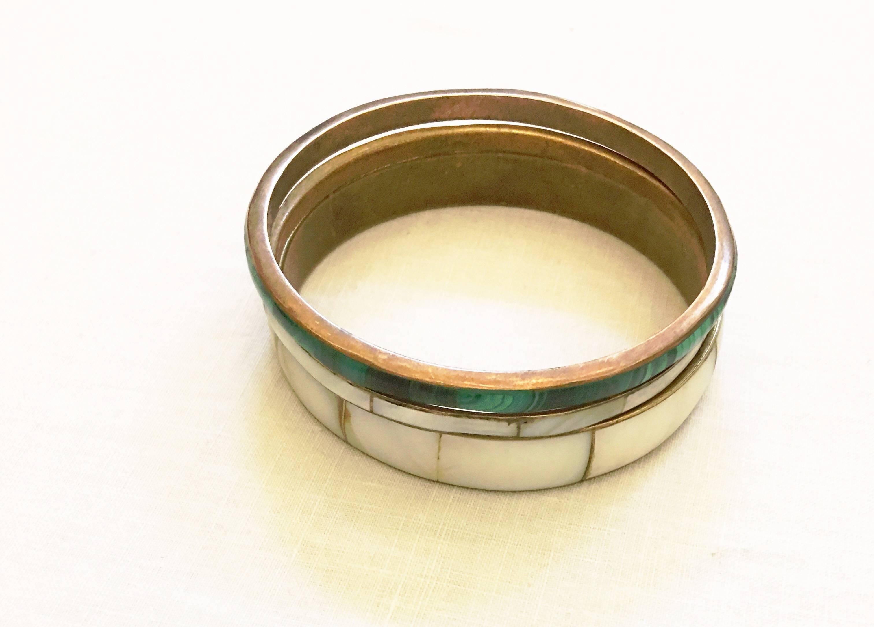 Set of five bangles- four abalone and two malachite. Malachite bangles are .2 inches in width and there are two abalone bangles of the same width and two that are thicker at .5 inches. 