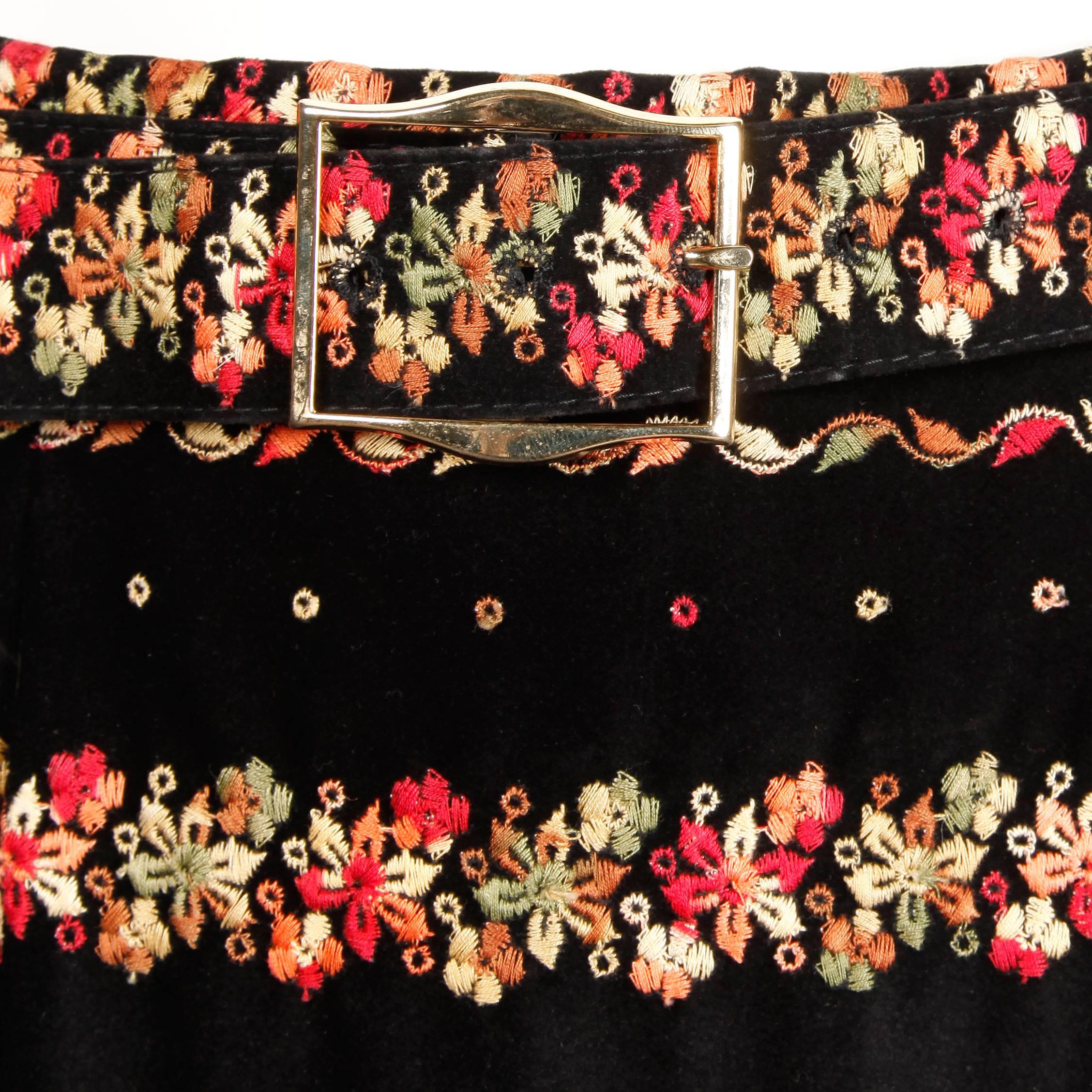 Gorgeous vintage black velvet maxi skirt with multicolor floral embroidery and matching belt. Unlined with side zip and hook closure. Fits like a modern size small. The waist measures 26
