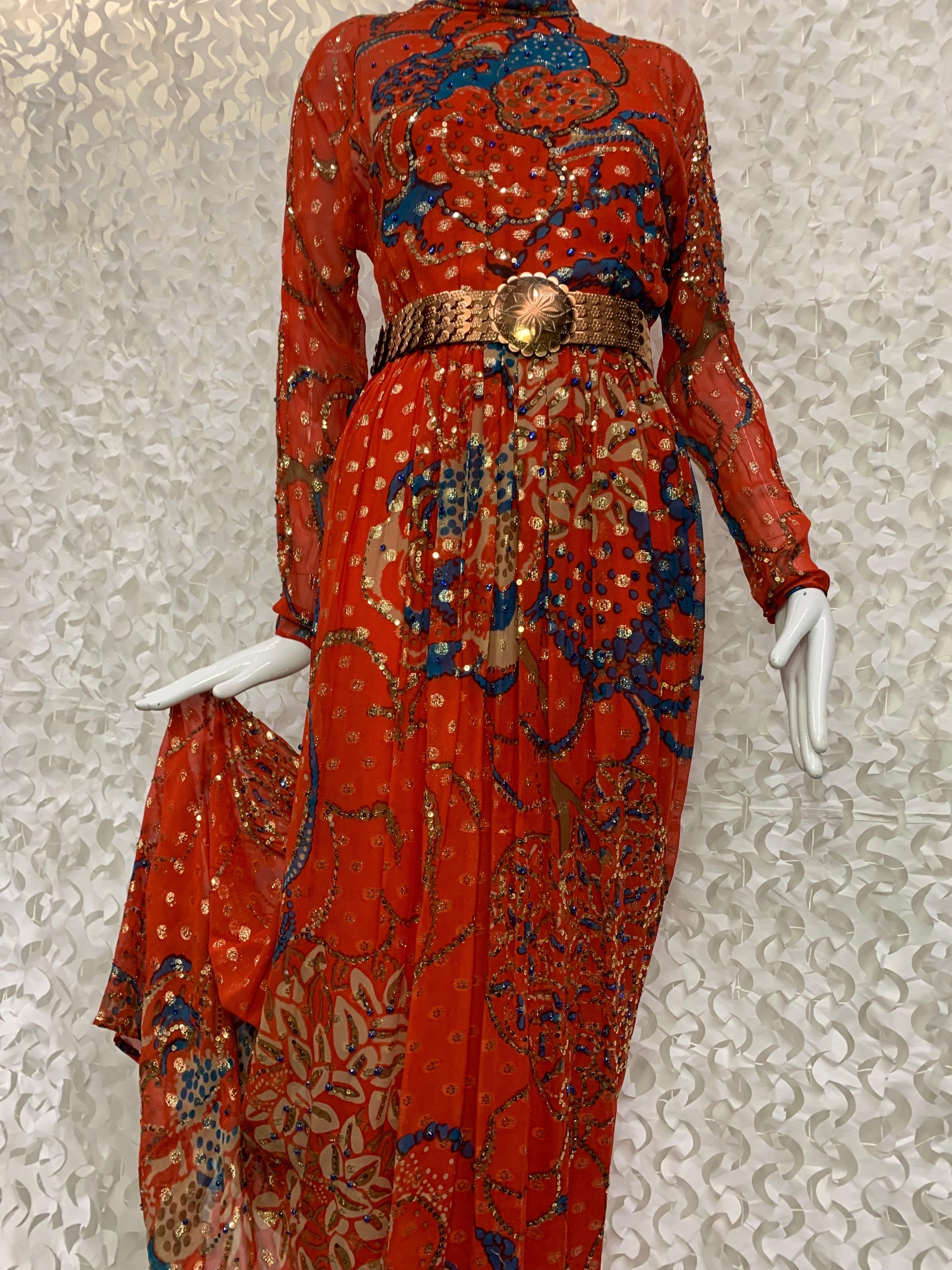 1970s Malcolm Starr Red Silk Chiffon Lame Maxi Dress w Asian-Inspired Floral:  This chic maxi with rolled neckline, sheer sleeves and back is shot through with gold lame dots and the blue branch print is accented with gold sequins. Covered buttons