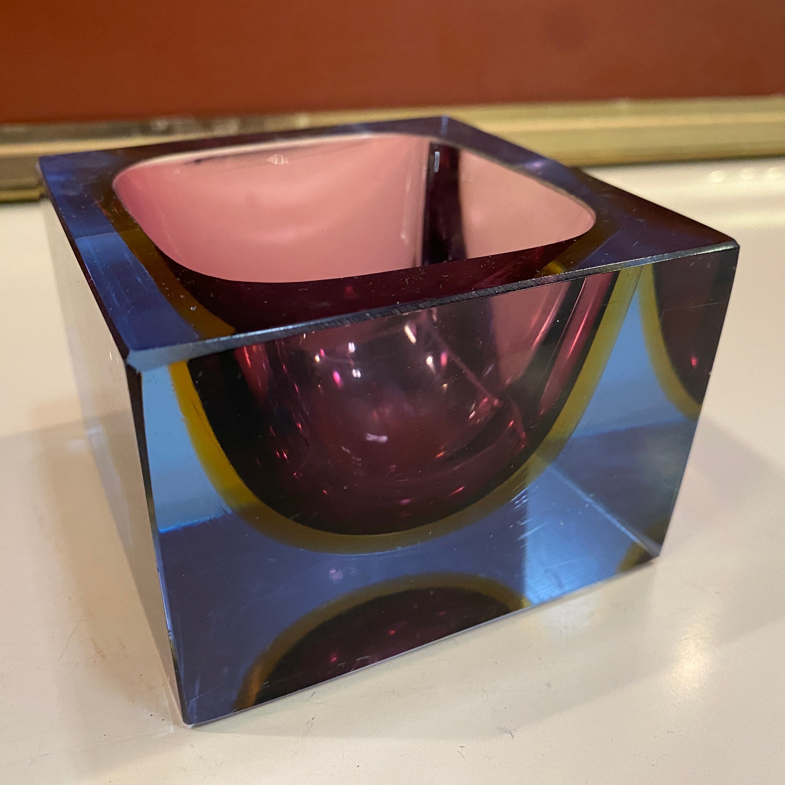A superb quality Modernist pink yellow and purple Sommerso Murano glass cubic ashtray designed and manufactured in Italy in the Seventies by Mandruzzato: It's in perfect condition.