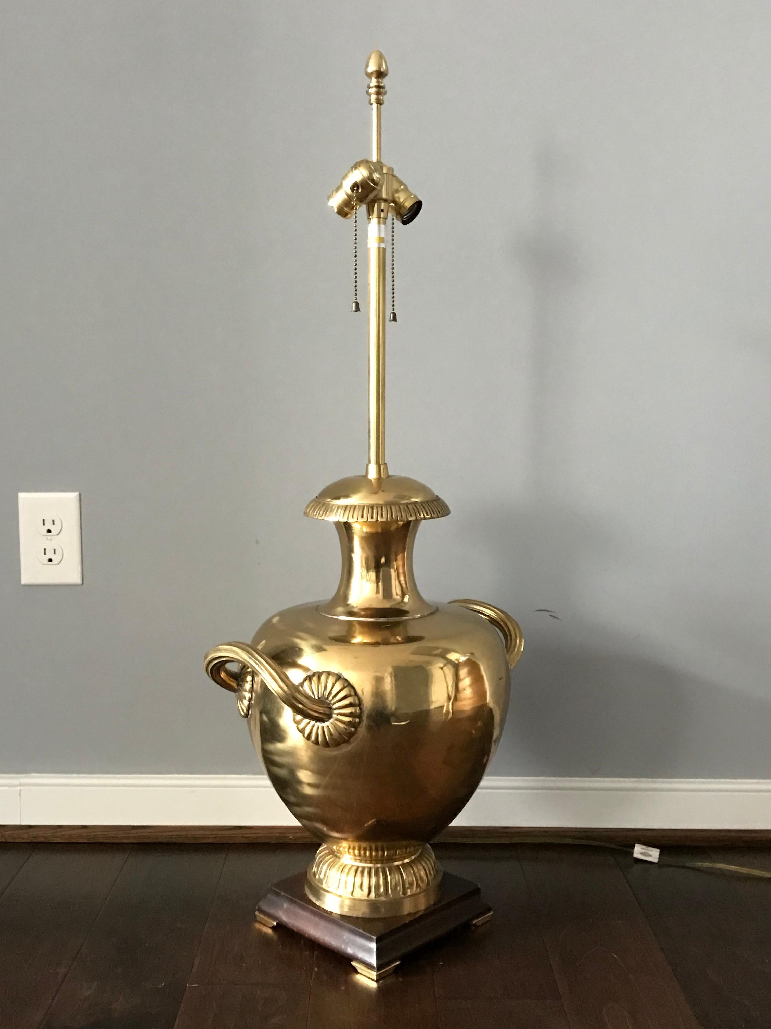 Offered is a stunning, oversized, 1970s Marbro of Los Angeles, California brass urn lamp. This piece has gorgeous detailing all over. heavily polished, double light-socket, original finial, and fabulous wood base with brass capped feet. Heavy,