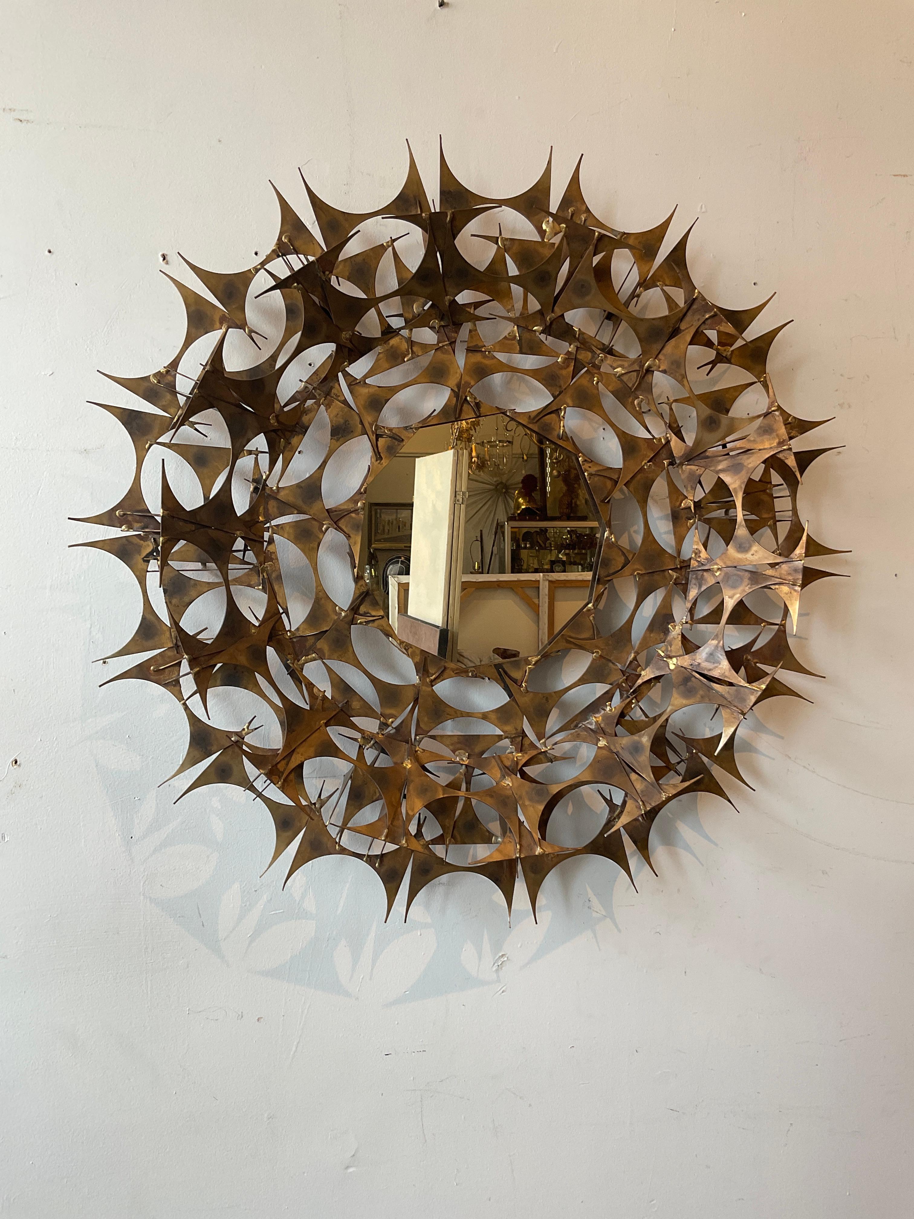 1970s Marc Weinstein brutalist sunburst mirror made from sheet metal with a painted finish.