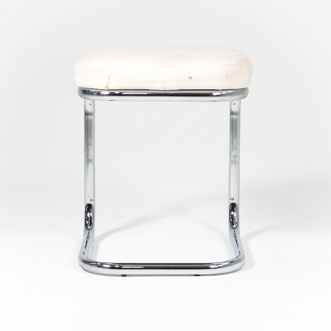 This is a Marcel Breuer Stool, originally designed for Thonet in the 1920s. This particular piece dates to the 1970s. The stool features Breuer's signature tubular chrome steel frame paired with an upholstered seat in off-white fabric.

The stool