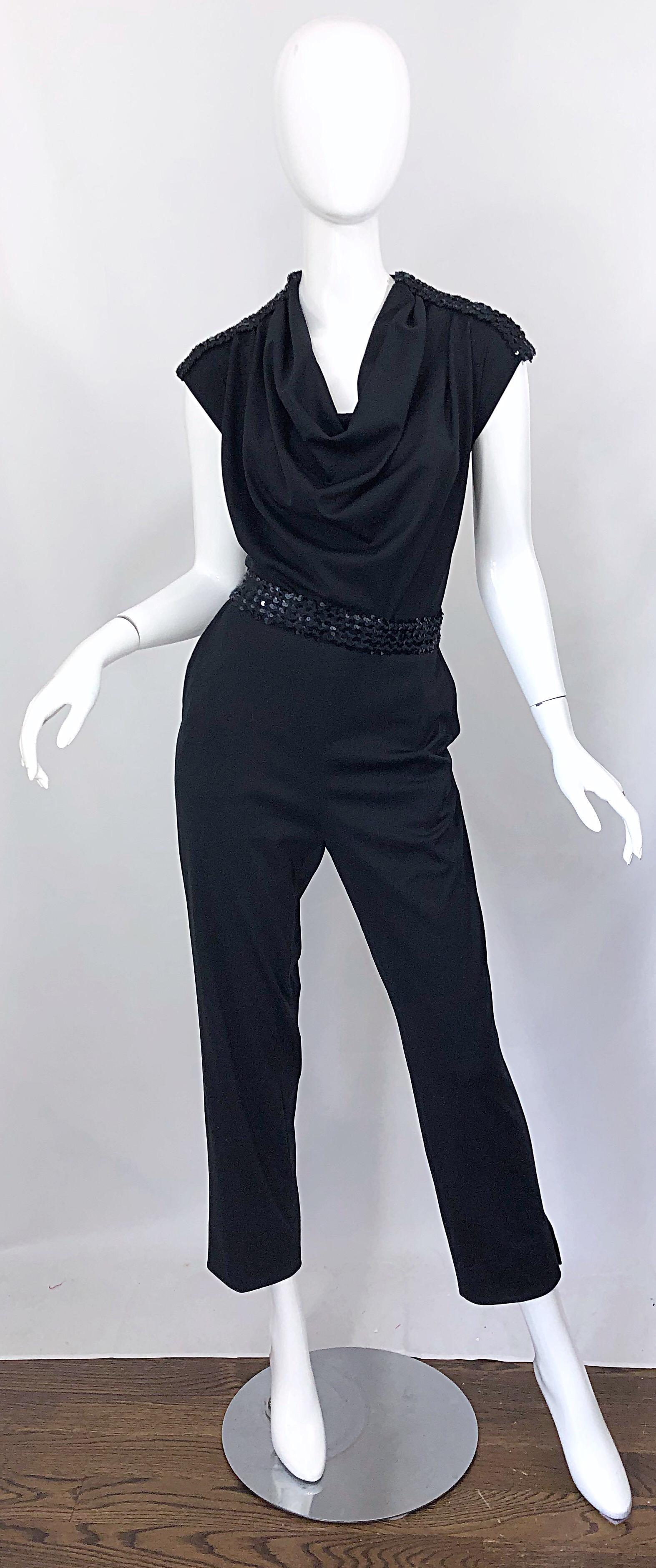 Amazing early 1980s MARYKA OF MONACO black jersey sequined belted jumpsuit! Features a slouchy draped bodice. Black sequins on each shoulder and allover the belt. Hidden zipper up the back with hook-and-eye closure. POCKETS at each side of the hips.