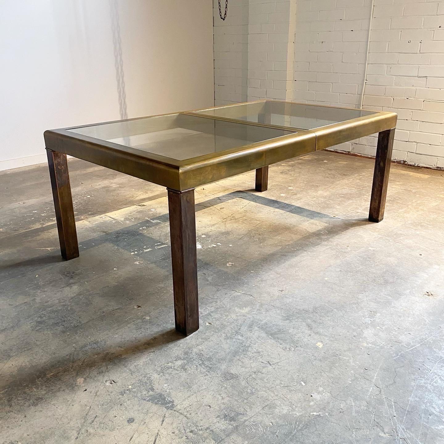 A striking heavily patinated brass dining table by Mastercraft. This piece is 72