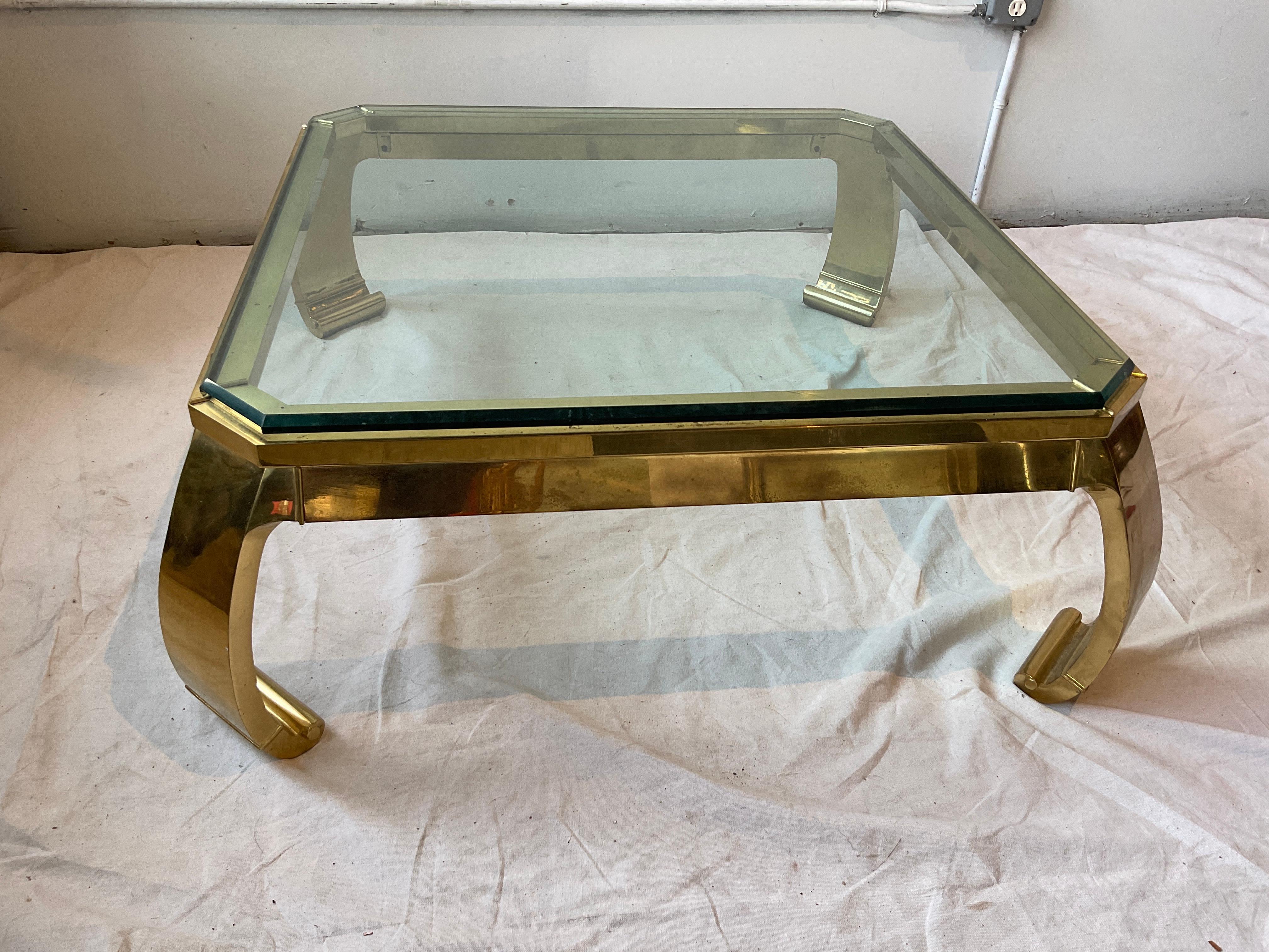 1970s Mastercraft brass and glass coffee table. Two available.