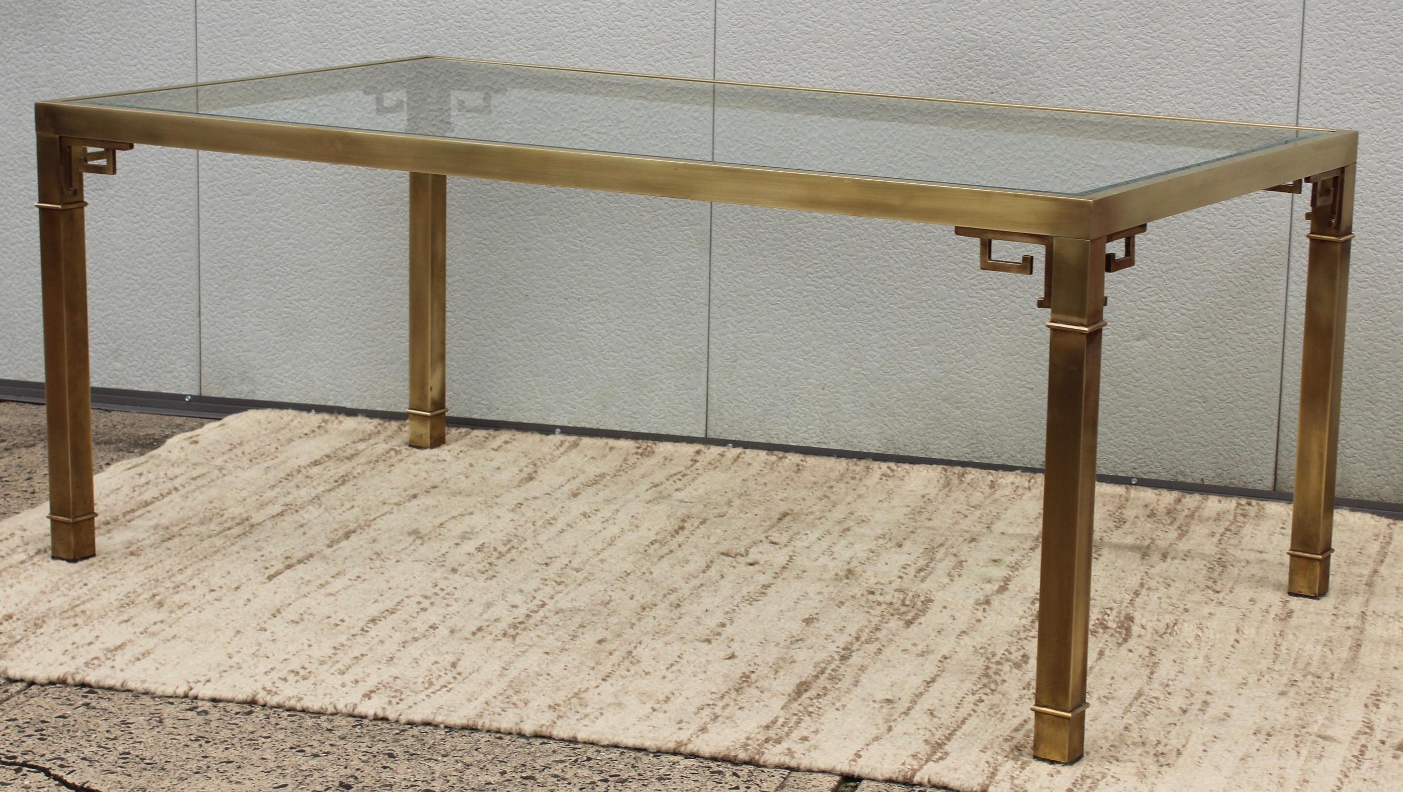 1970's mid-century modern Greek key brass dining table by Mastercraft, in vintage condition with some wear and patina due to age and use, the table has been gently hand polished it shows some wear.