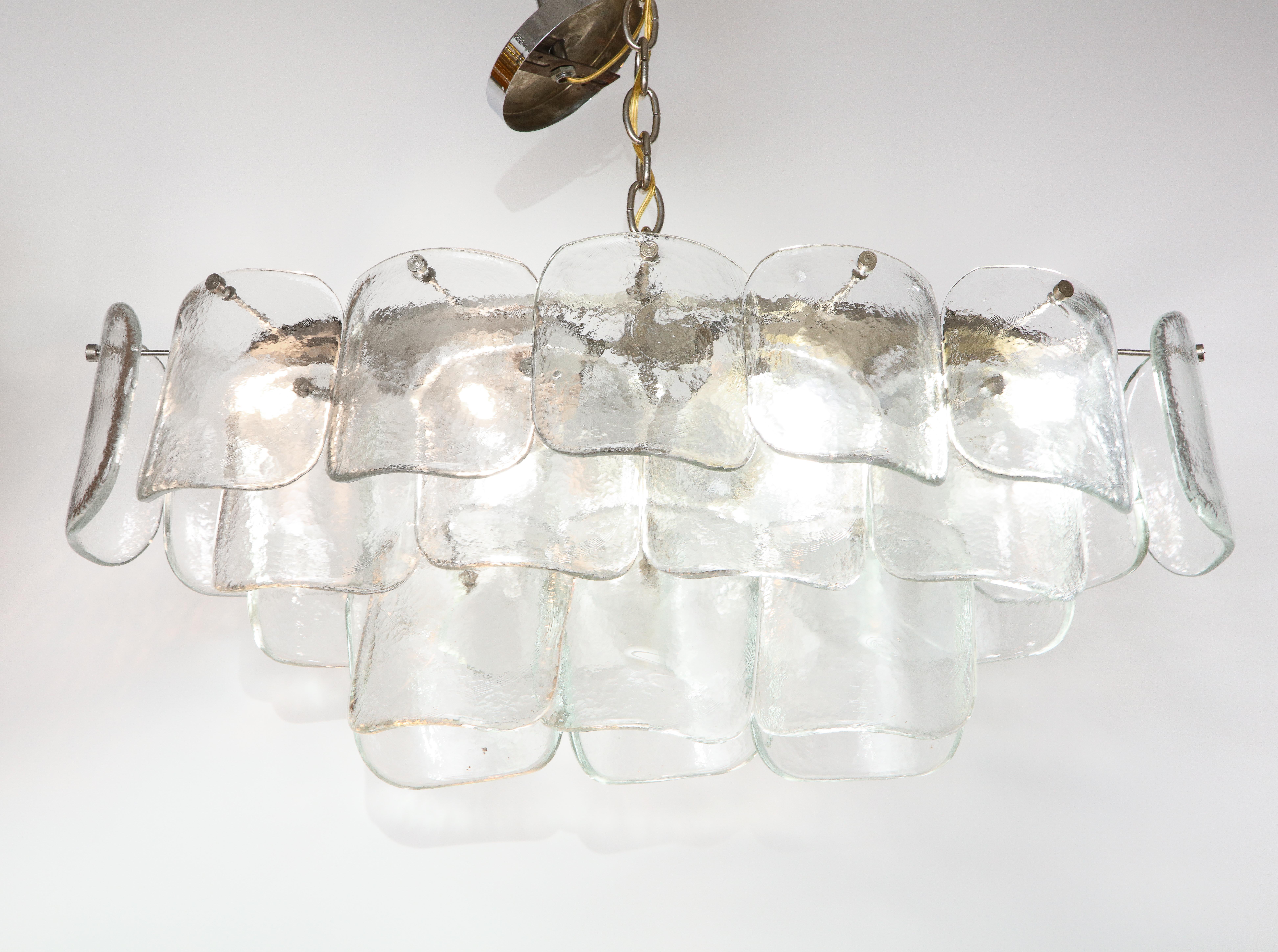 Stunning 1970s clear glass oval glass chandelier by Mazzega for Murano. With 26 glass discs and chrome frame and hardware, still retain the original Murano label.

Height including chain 67'' the height can be adjusted.
