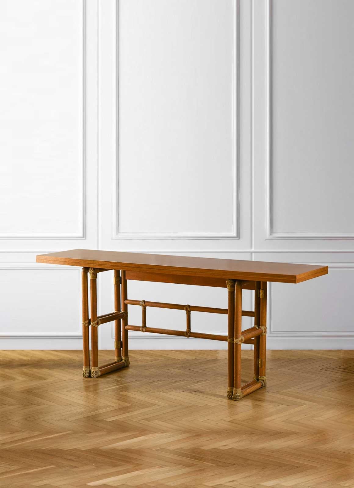 Lyda-Levi-McGuire console with flip-top top 1970. 
Made of rattan, wood and leather bindings.
Label applied under the table top.
Product details
Dimensions (closed): 183 W x 75 H x 45 D
Dimensions (opened): 183 W x 75 H x 90 D
Production: Lyda
