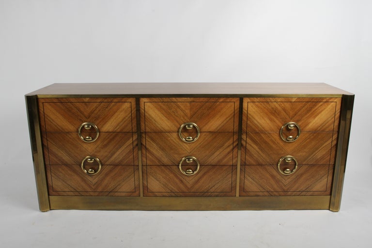 Newly restored Mid-Century Modern or Hollywood Regency 1970s Mastercraft six drawer dresser in bleached Rosewood. Drawers are dovetailed, drawer fronts veneer has a chevron pattern with custom brass handles and brass trim around front of case with
