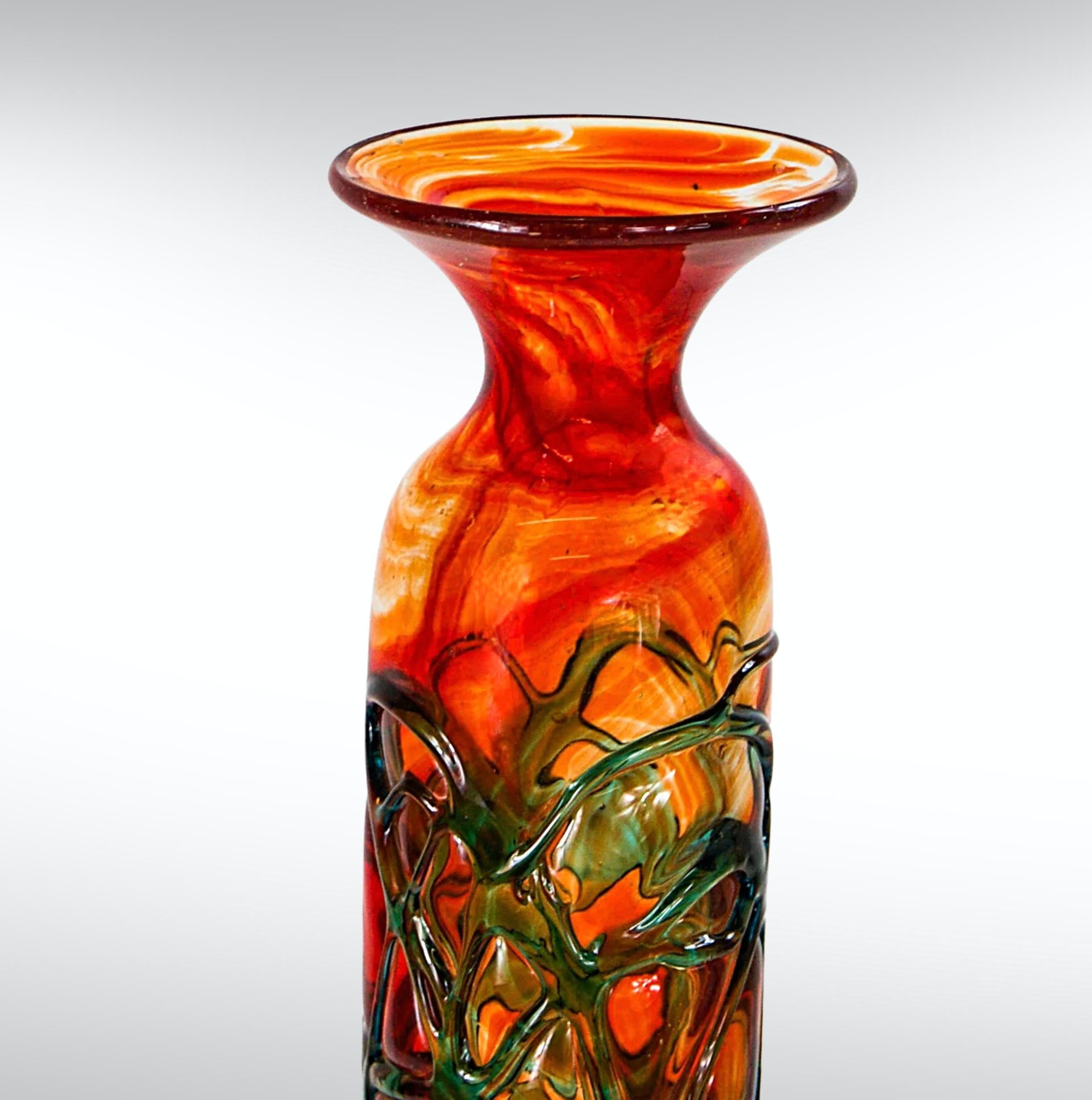 1970s Mdina glass tall vase.
Design by Michael Harris for Mdina glass, circa 1970s.
Fire orange color with greenish appliqué stripes around the stem.
Substantially sized at over 30cm with a wide minaret neckline. 
Brutalist textured glass