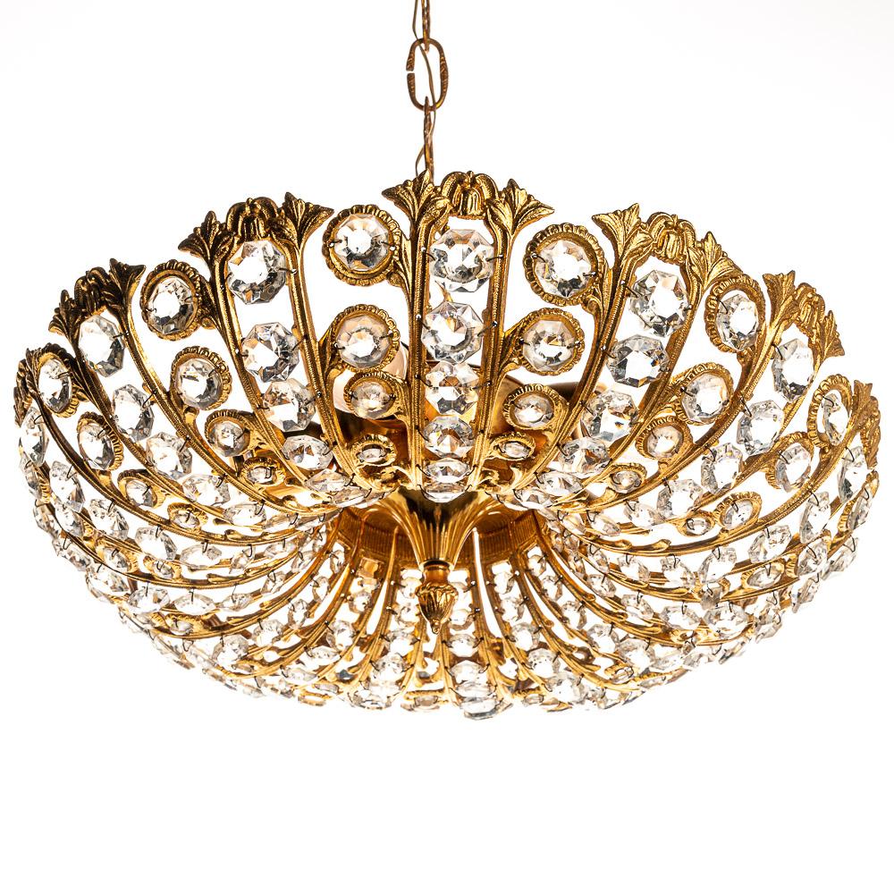 This is a wonderful design made in the 1970s and it sparkles when lit up by the five E27 bulbs. Glass gems and gilt metal frame. The combination of these materials expertly crafted give this piece a real ritzy feel.