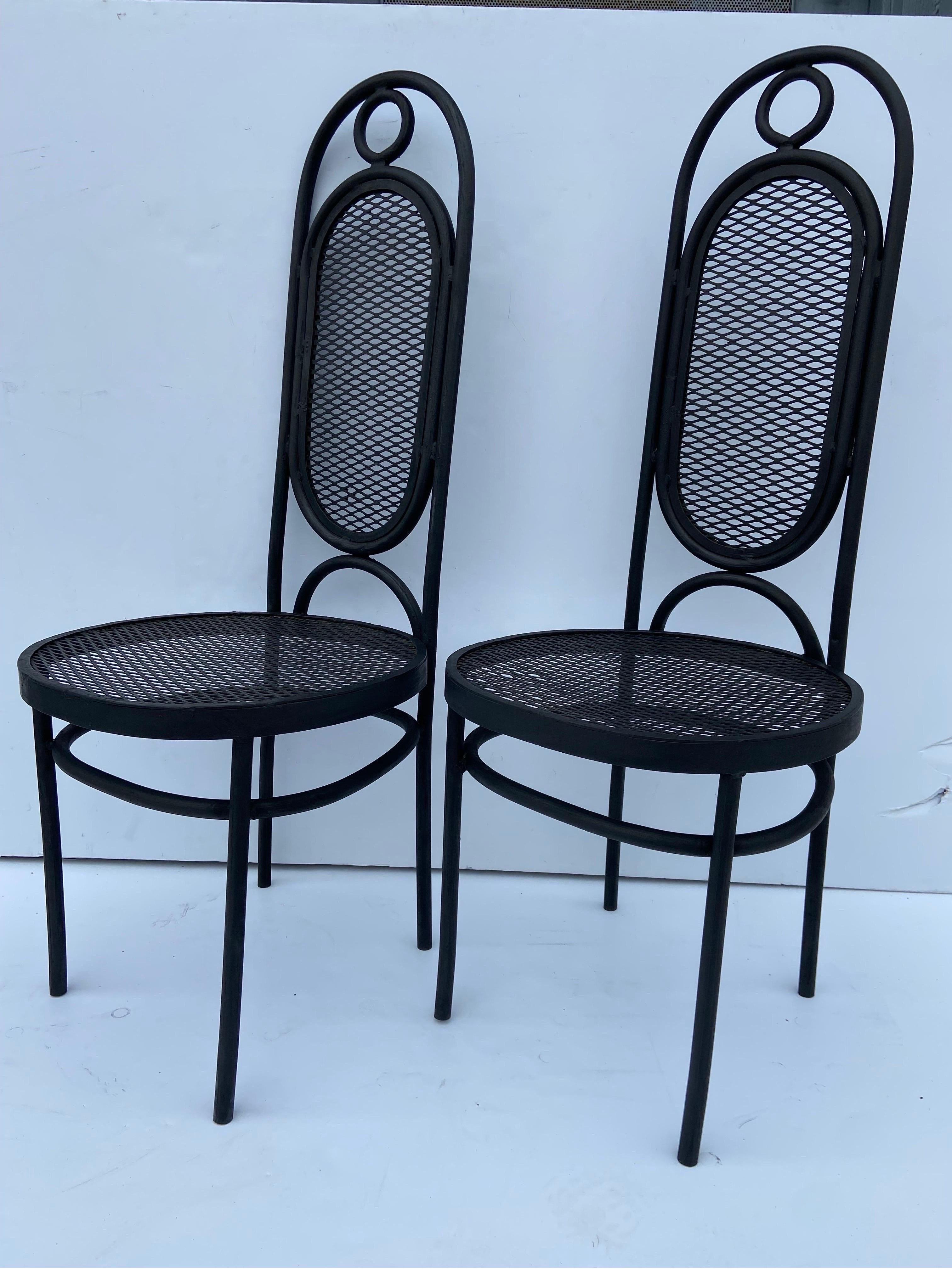 A vintage circa 1970's pair of Mexican iron garden or side chairs done in the style of the well known Model 17 chair designed by Michael Thonet and produced by Gebruder Thonet in the early 1860's. This pair of iron chairs, dates to circa 1970's,