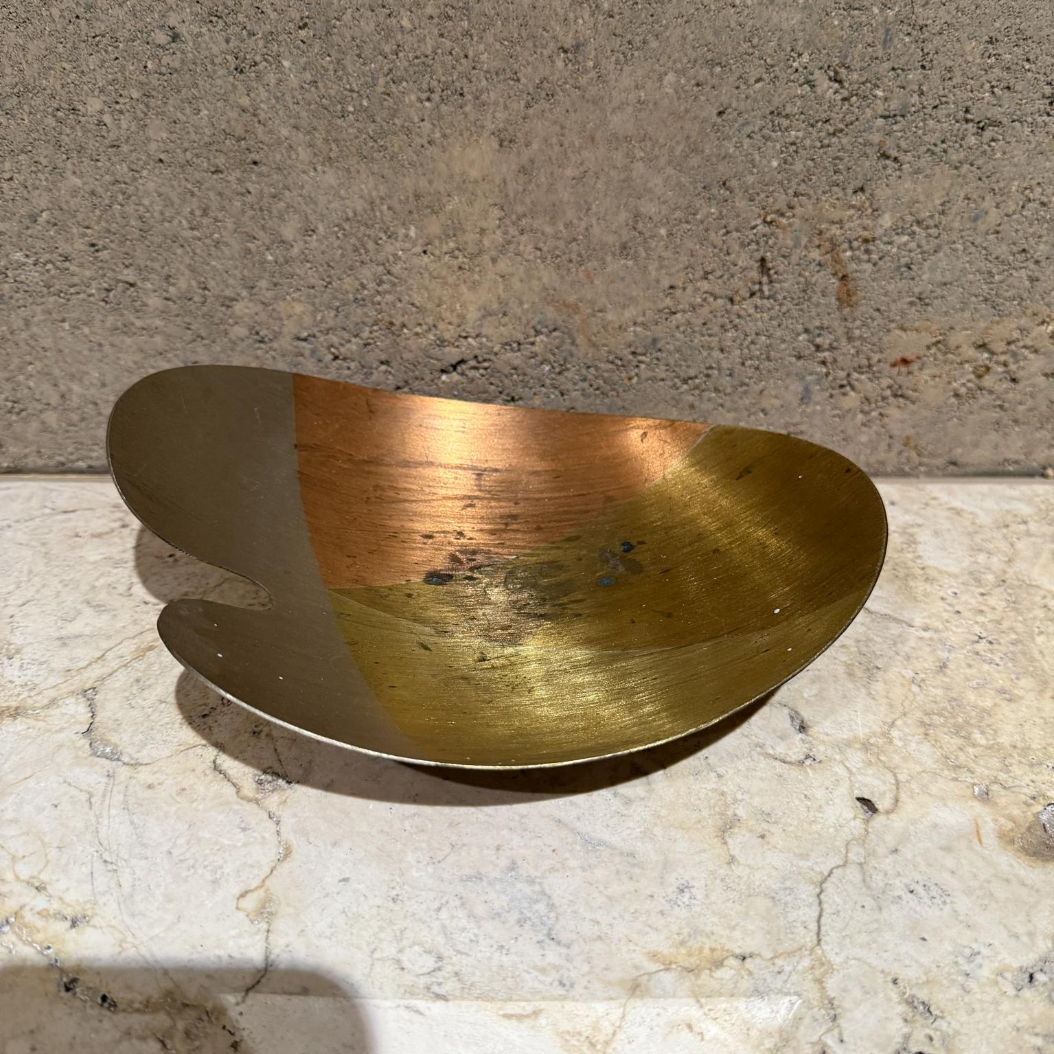 
1970s Mexican Mixed Metal Footed Dish
2.75 h x 8.38 x 6.5
Metales casados organic shape. Mounted on three balls.
No stamp. Made in Mexico. Style of Los Castillo.
Vintage patina. Not new. Unrestored. Original vintage.
Refer to images.