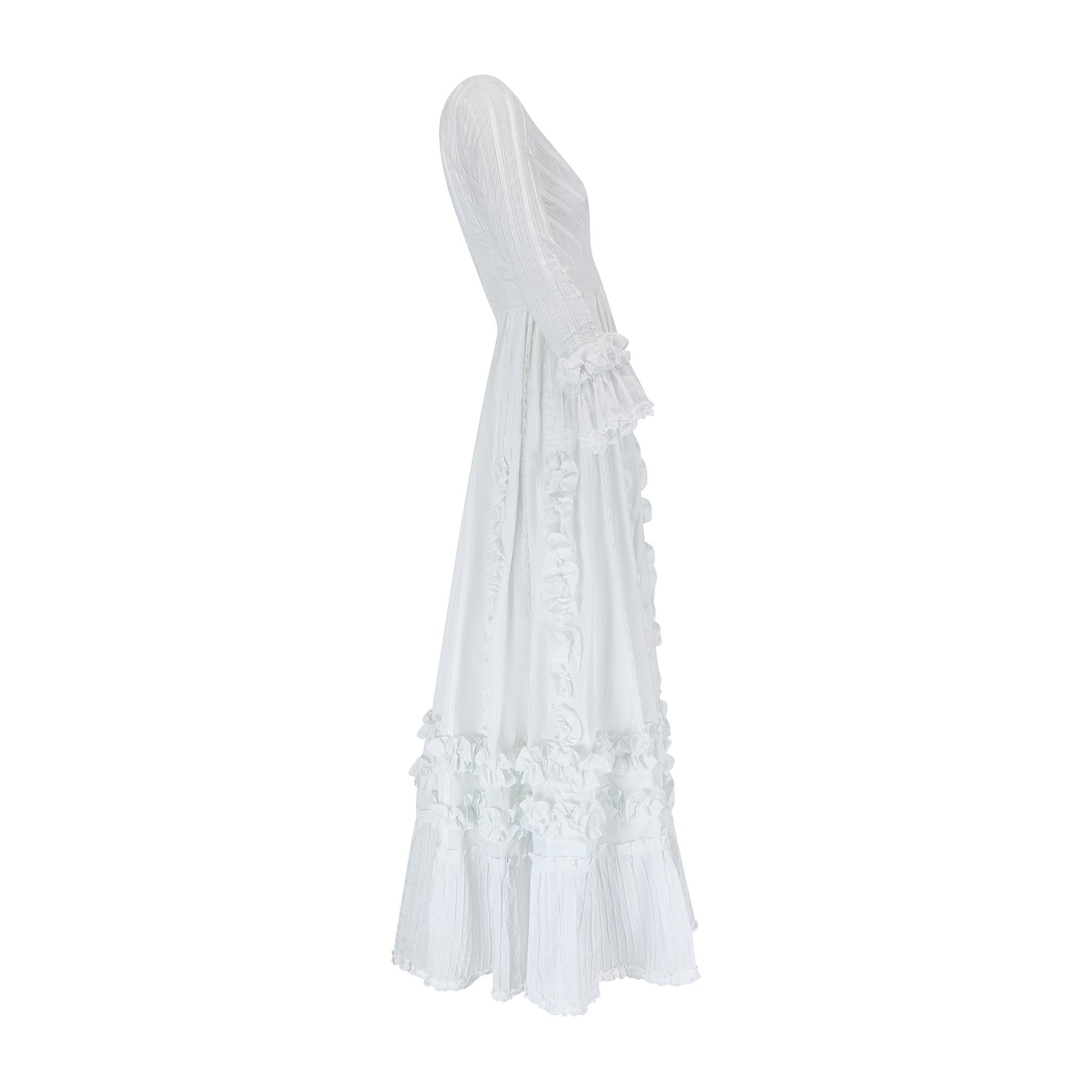 Sublime late 1970s to early 1980s Mexican wedding dress from the legendary Mexicana boutique which was located just off the Kings Road in London. Pleated all over, it is made from bright white cotton which has been intricately pin-tucked all over