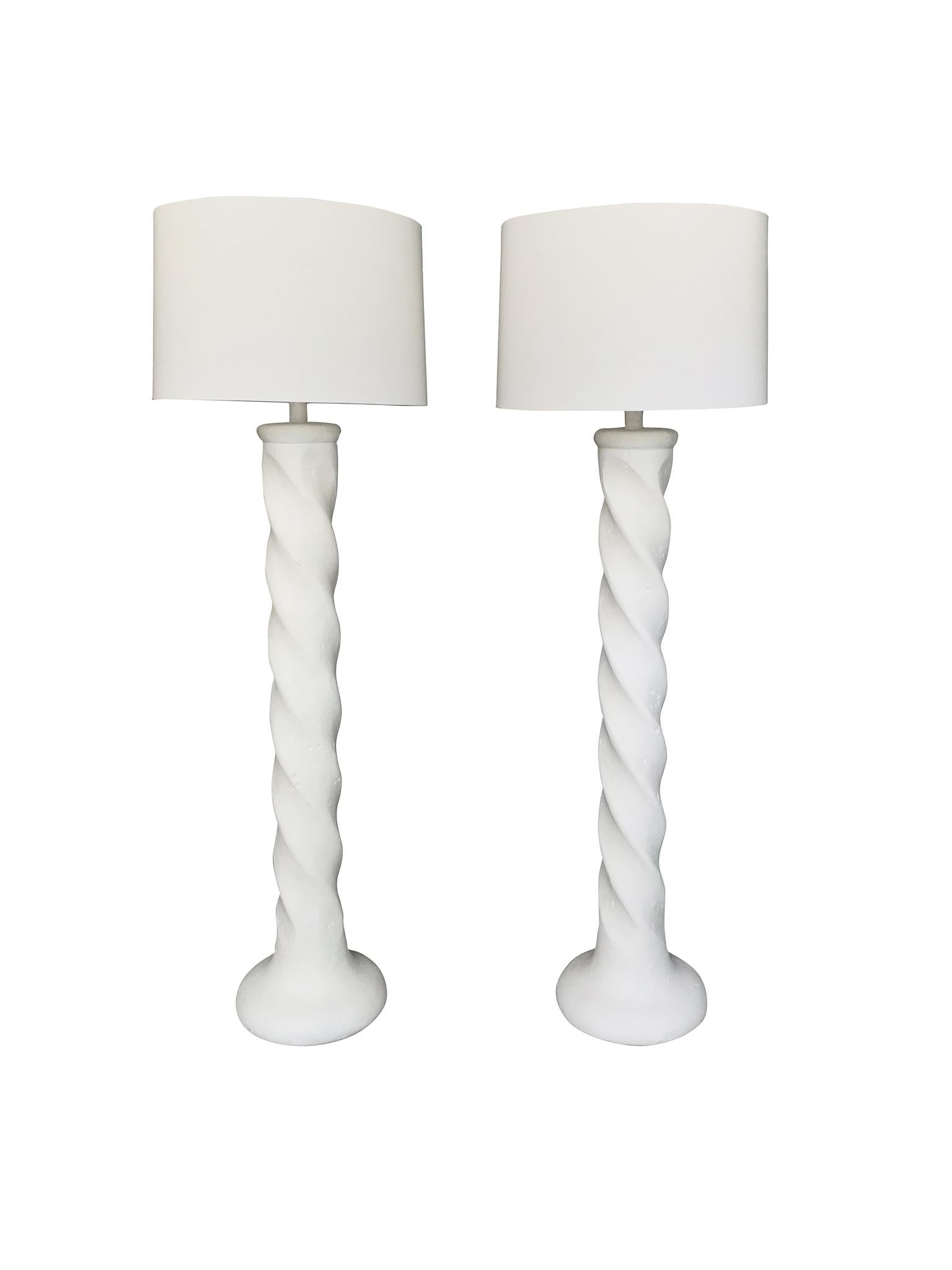 A Neoclassical-style pair of white column floor lamps by Michael Taylor. Made in the 1970s. Newly rewired with a single bulb sockets. New hardware. The lamps consist of plaster and new custom linen shades. Taylor's dynamic design is reminiscent of
