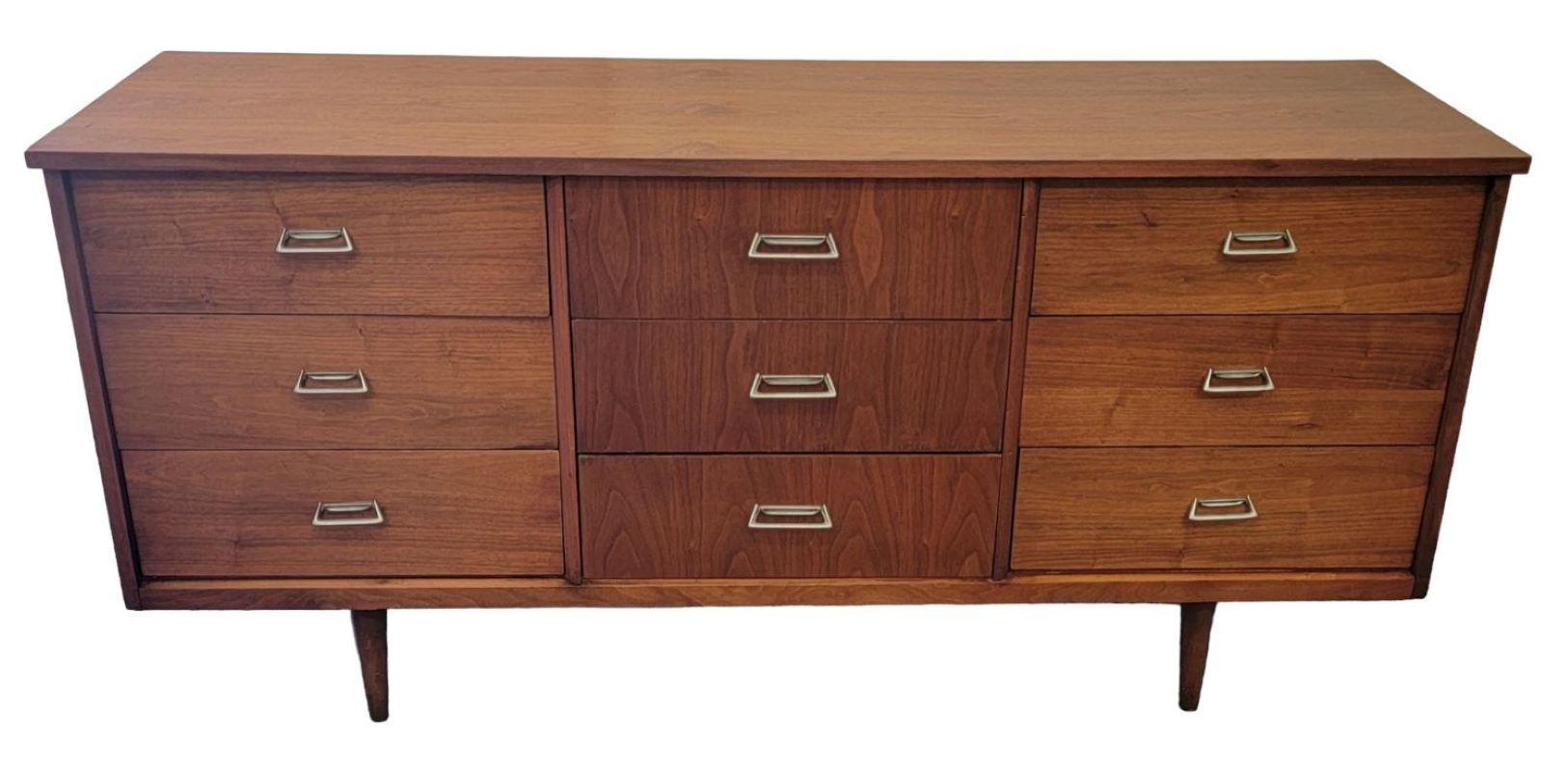 Midcentury wooden 9 drawer Credenza.
The handles are made from a brass mold and are secure and strong.
The legs/feet on this credenza are very strong. 

This credenza is in amazing condition the wood shows off the grain in a wonderful glowing
