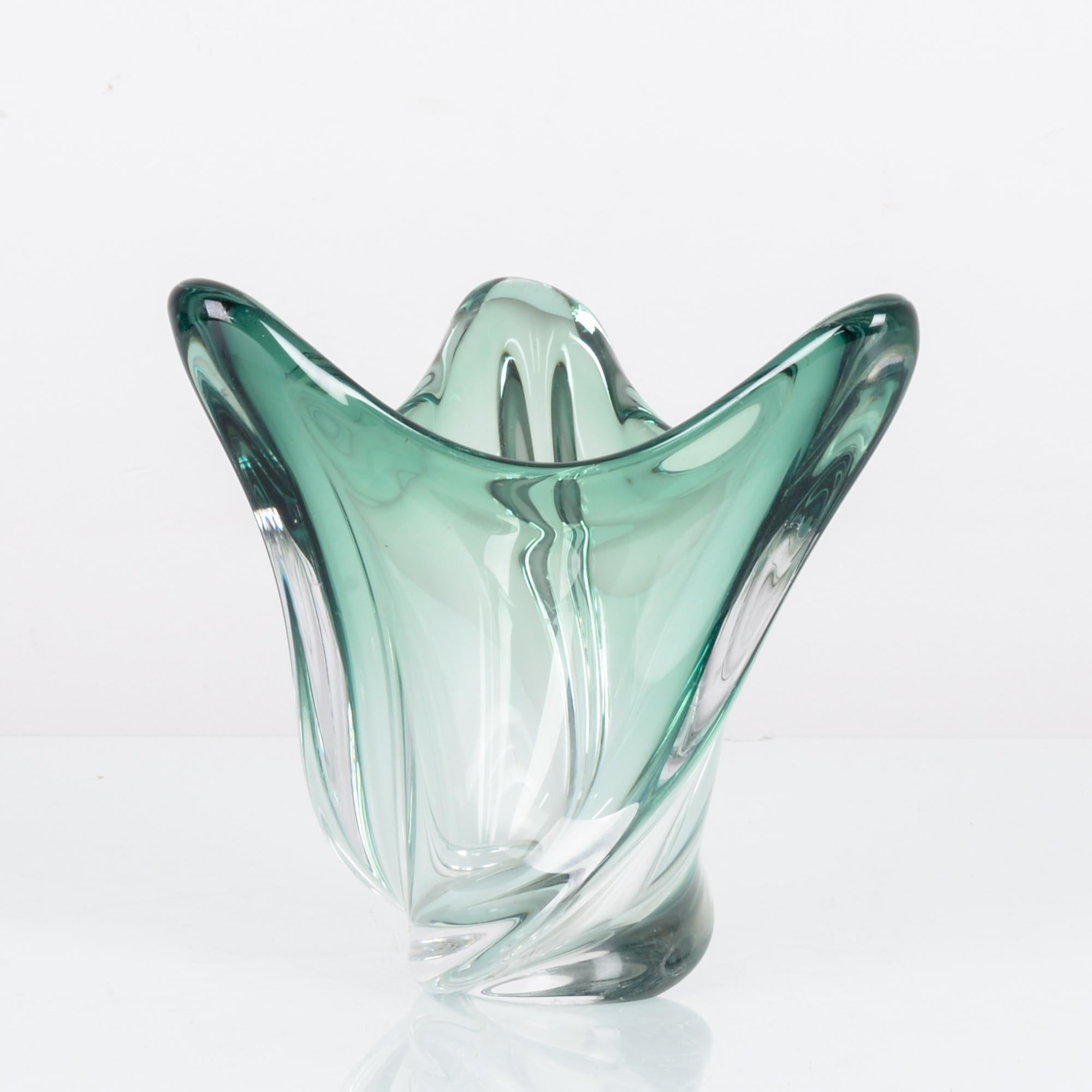 This glass bowl was made in Belgium, circa 1970. It resembles a flower with three petals, tinged myrtle green in the upper section. With its elegant form and lustrous quality, this glass decorative piece will bring refinement and style to your