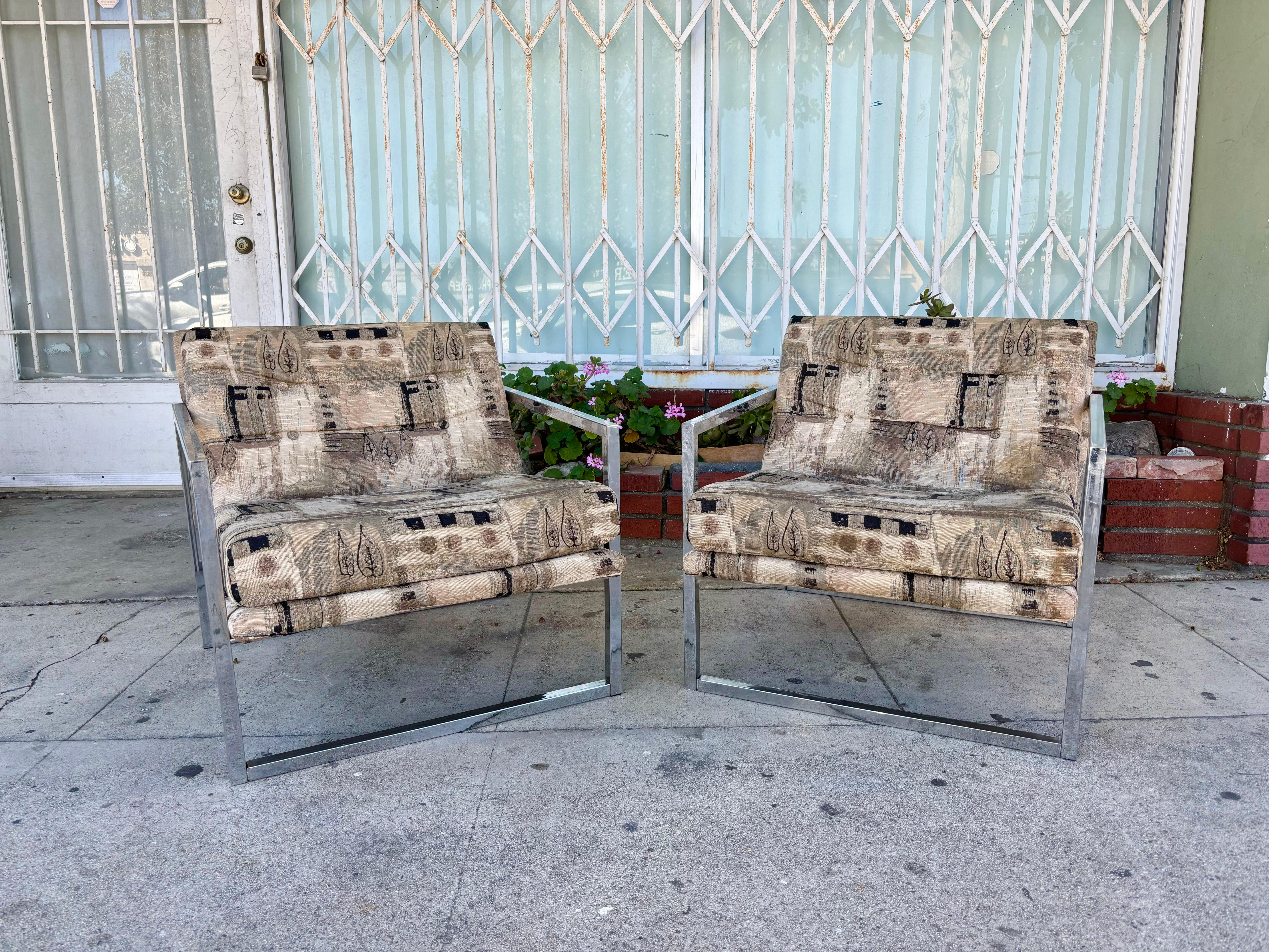Mid-century scoop chrome lounge chairs designed and manufactured in the United States circa 1970s. These chairs are truly eye-catching, featuring a beautiful gray upholstery that sits elegantly on top of a sleek chrome base. What sets these chairs