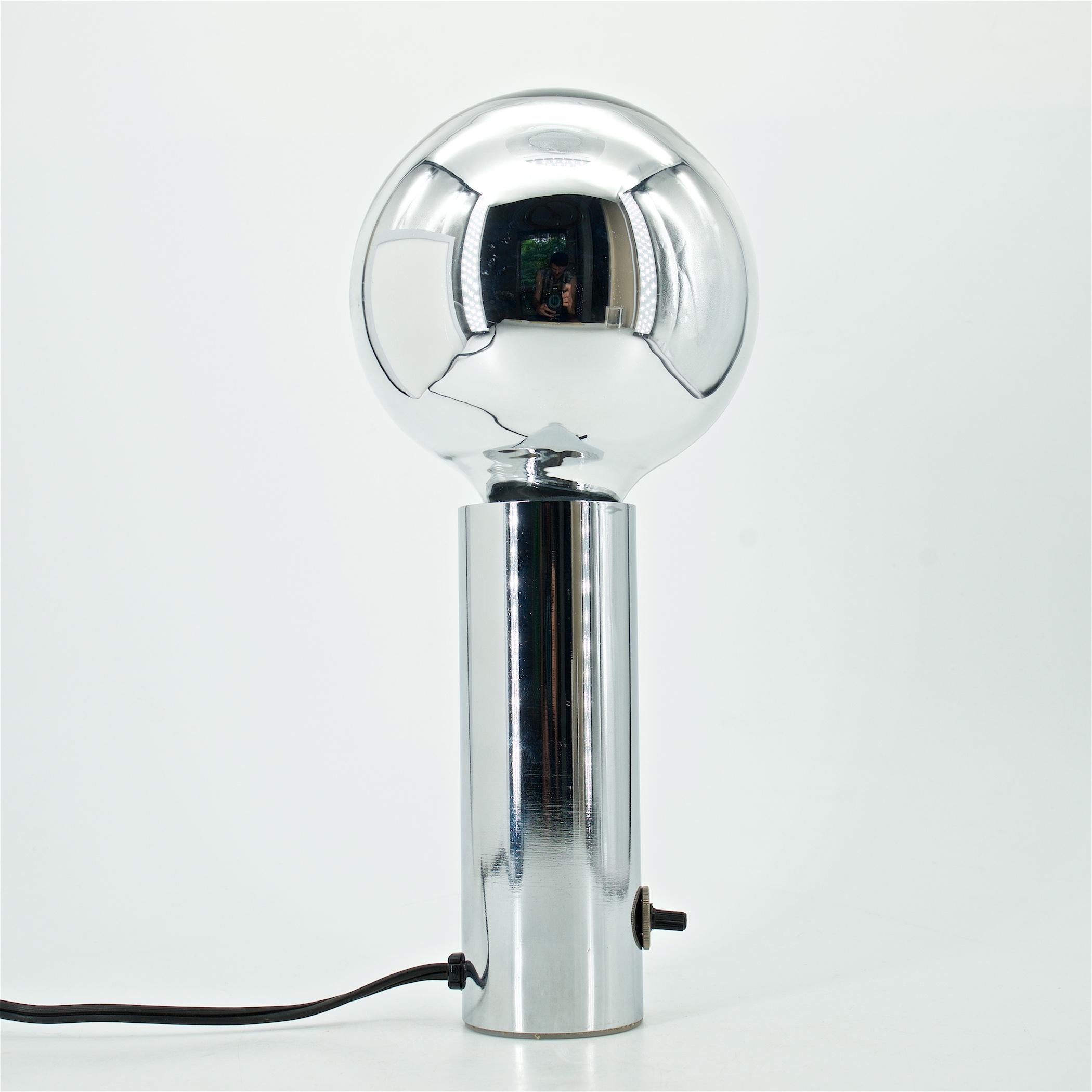 Wonderful 1970s accent lamp. Taos designs Inc. Polished/chromed steel cylindrical dimmable table lamp with large chrome bulb.