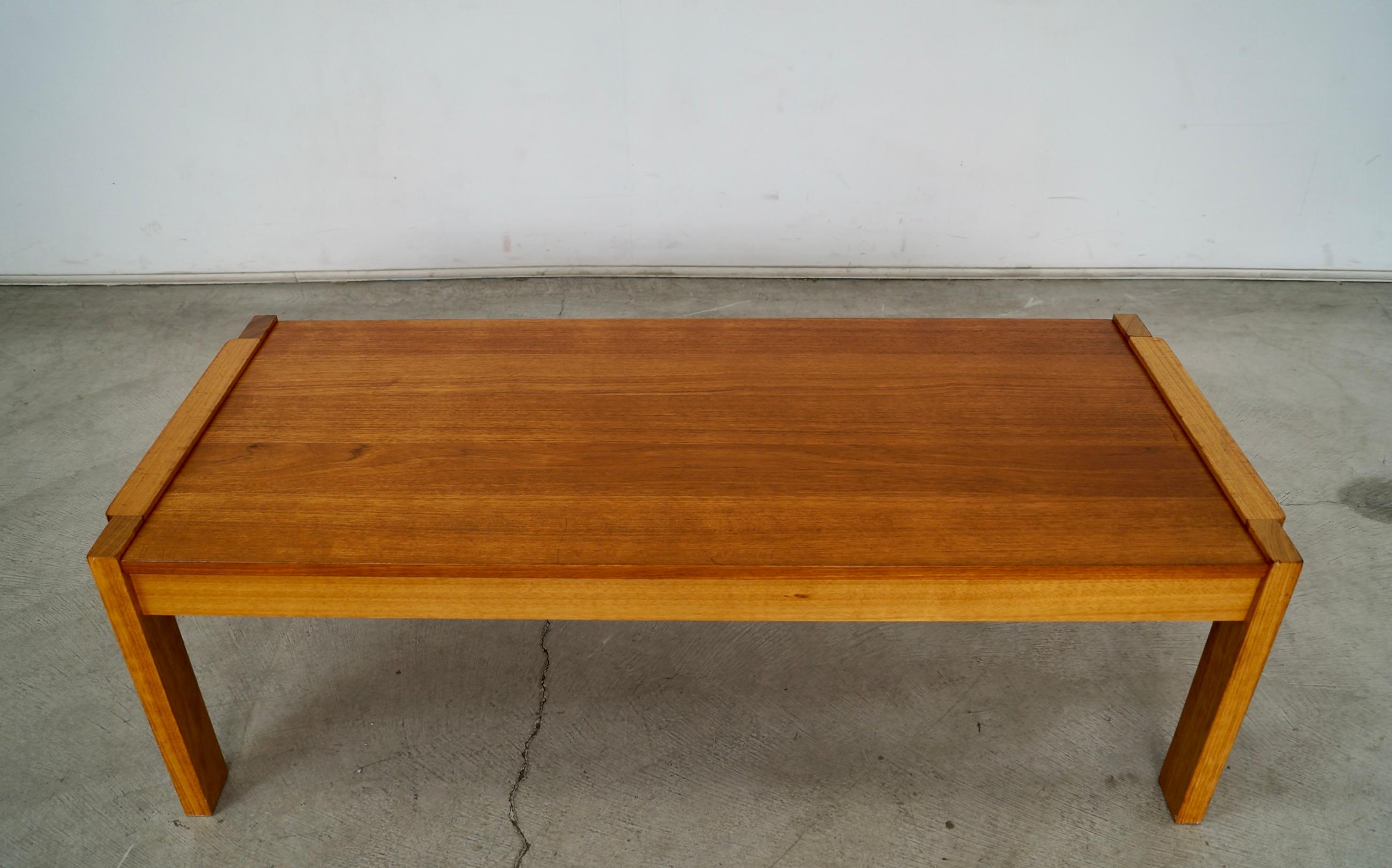 Vintage Midcentury Modern coffee table for sale. Has a cool design, and was made by RS Furniture in Canada. Rare design piece in teak and mahogany frame and legs. Great two tone wood aesthetic going on. Very solidly built, and in great vintage