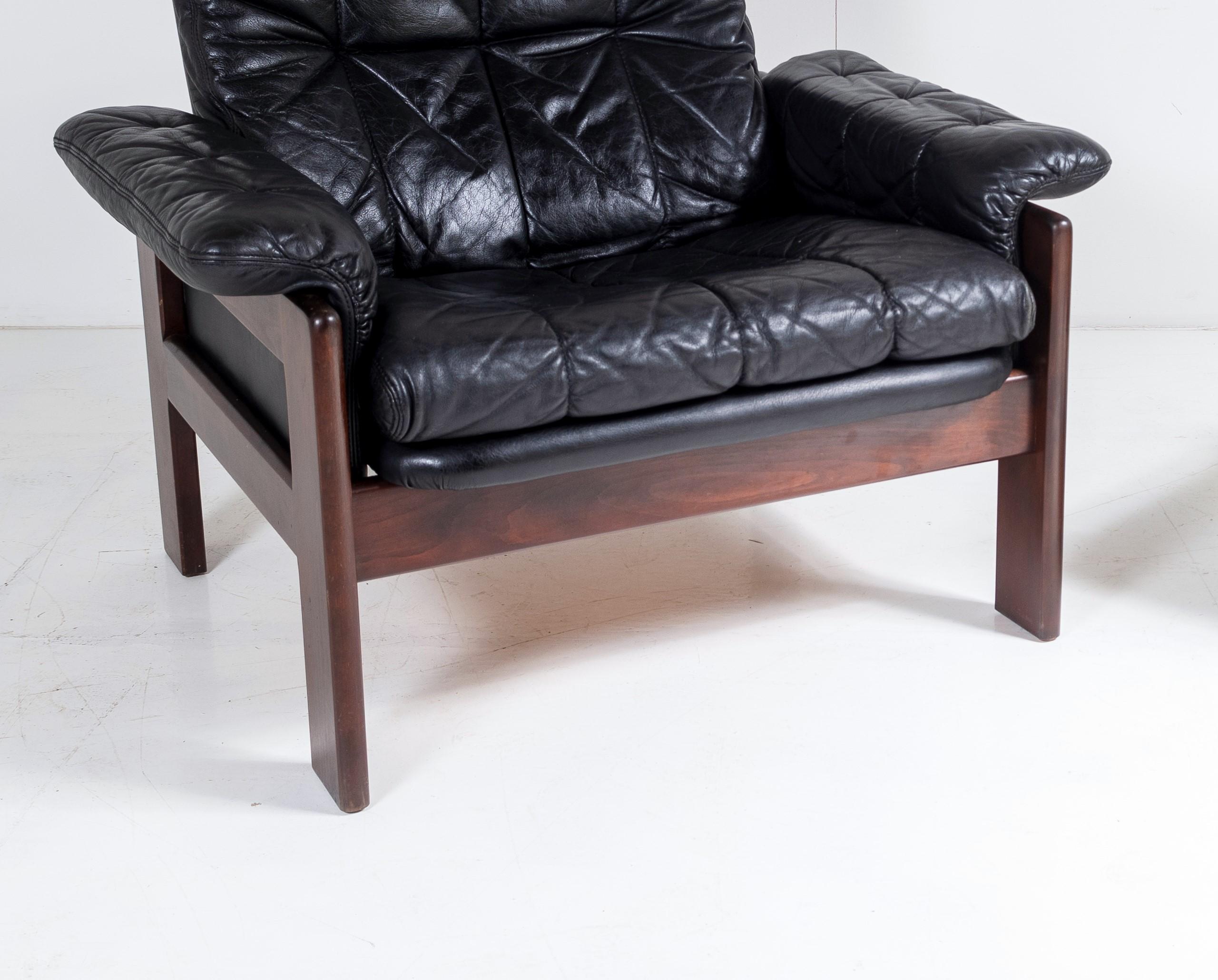 Mid-Century Modern 1970s Mid Century Danish Teak Rosewood and Black Leather Armchair and Footstool For Sale