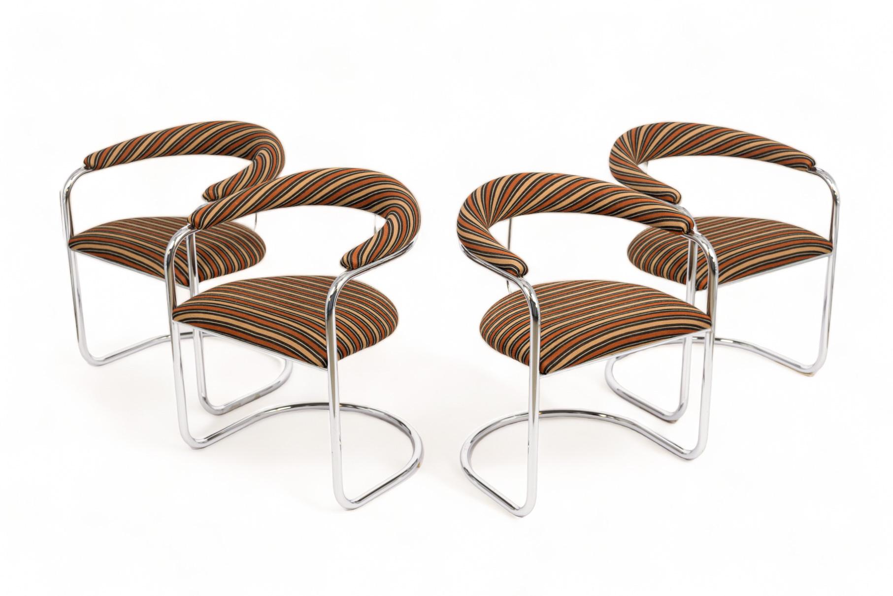 This set of four vintage mid century modern SS33 dining chairs were designed by Anton Lorenz and manufactured by Thonet. These iconic Bauhaus arm chairs feature chrome-plated tubular steel cantilevered frames with striped upholstery fabric on seat