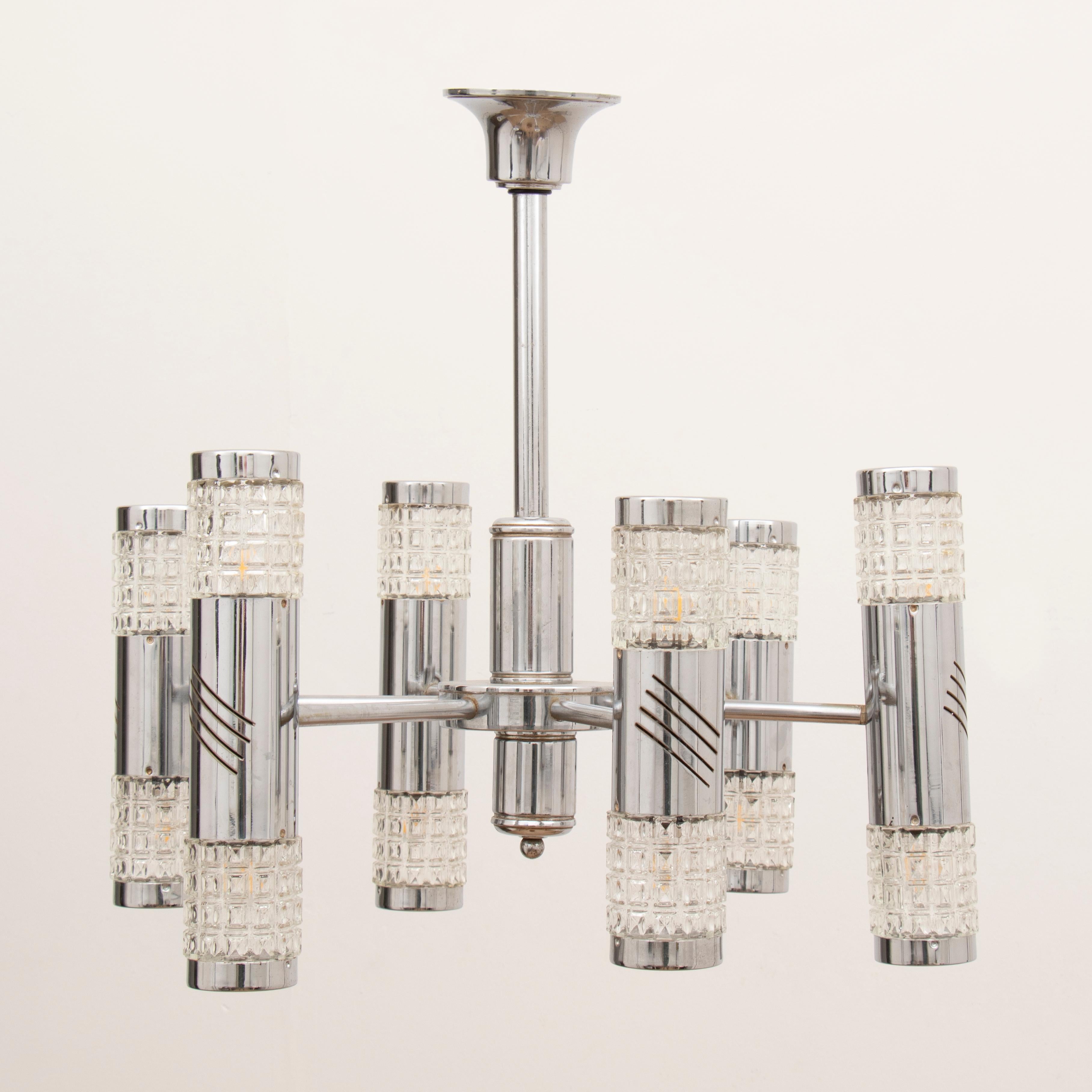 A striking and unusual 1970s Kinkeldey hanging light, featuring six-arm vertical chrome and glass tubed lights. Each tube is illuminated at both the top and the bottom with a chrome cap top on each one. The six arms tubed are attached to a central