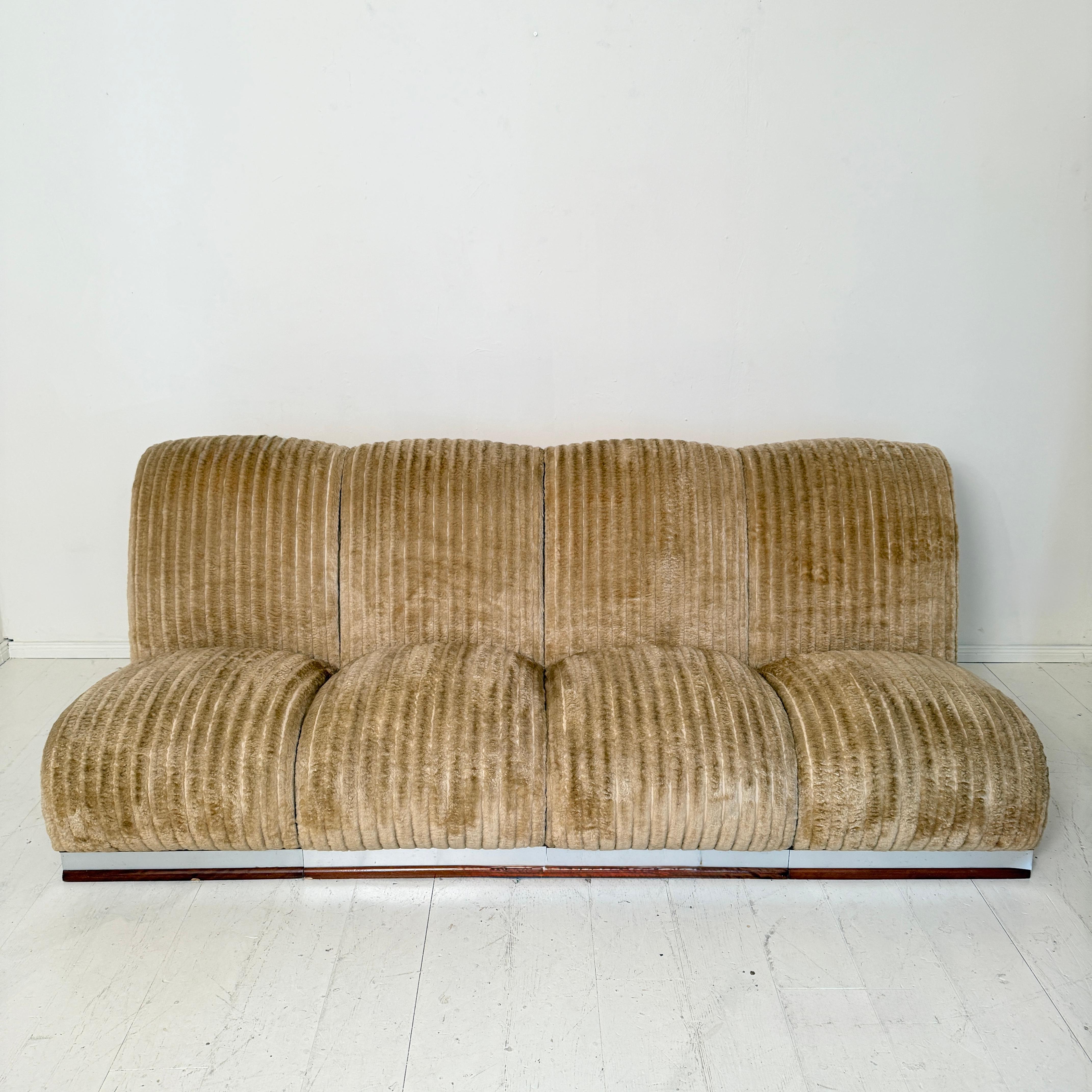 A stylish Mid-Century Italian modular sofa from around 1970, retaining its original beige cord fabric. The design reflects the era’s fascination with organic forms and comfort, featuring sculptural curves, deep seating, and soft upholstery that