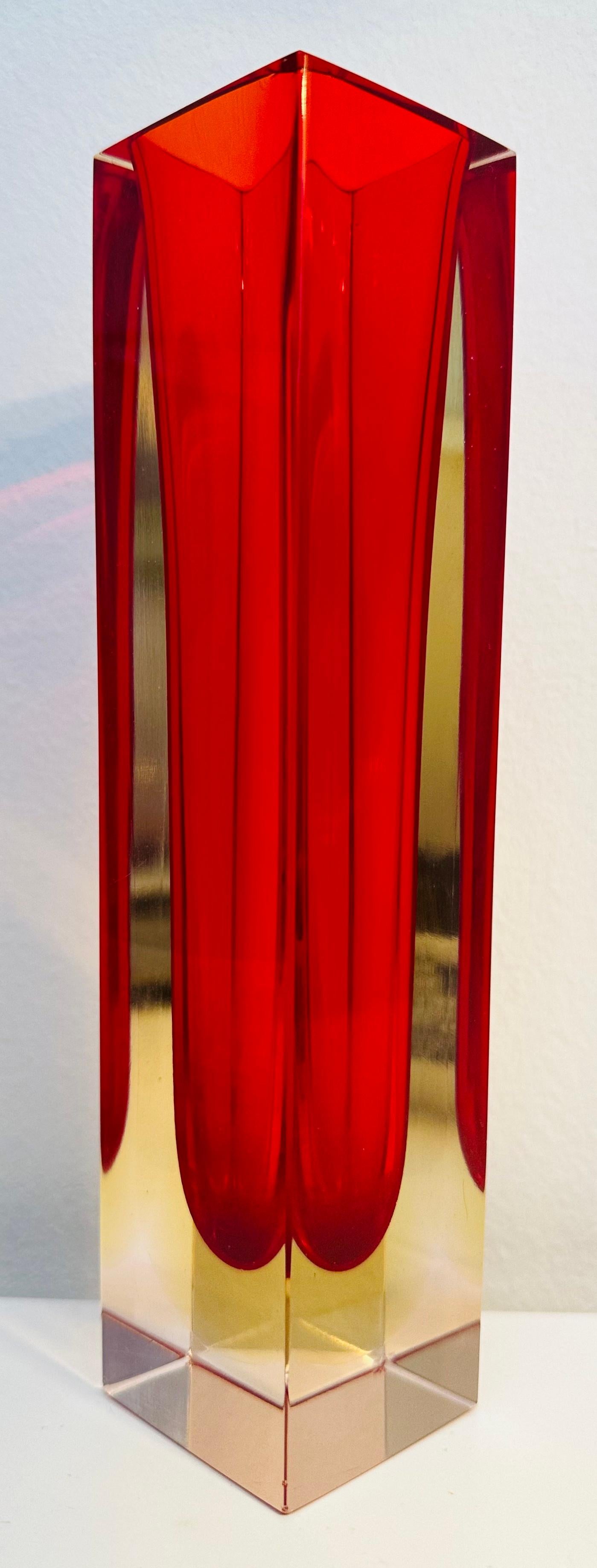 1970s Murano red, yellow and clear encased glass vase. A beautiful decorative piece perfect for a glass display case or shelf where the light can shine through it to emphasise the beautiful coloured glass. The vase is made in the Sommerso
