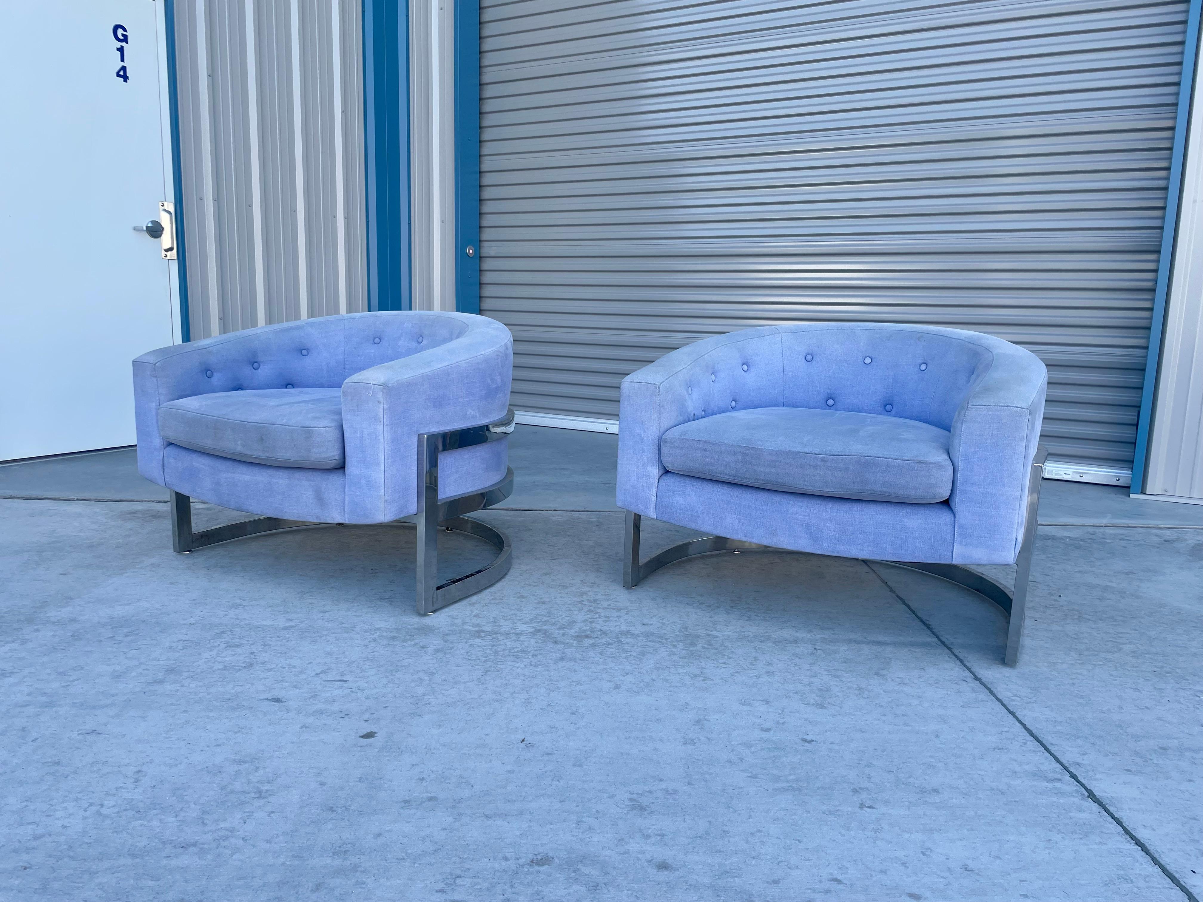 Mid-century barrel chairs were designed and manufactured in the United States circa 1970s. These beautiful pair of lounge chairs feature a barrel shape design on top of a chrome base wrapped around the seat, giving you the illusion that you're