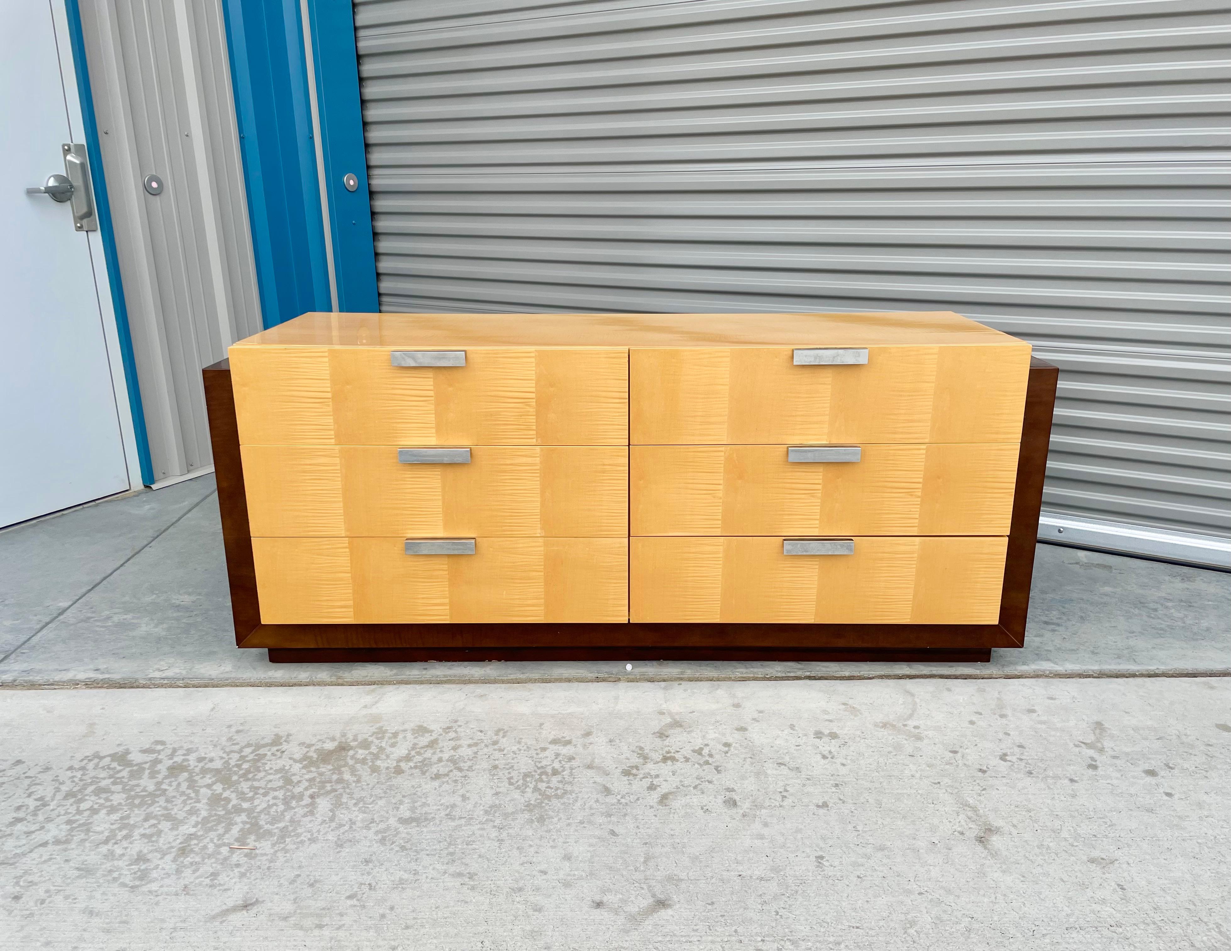 Mid-century maple and walnut dresser was designed and manufactured in the United States circa 1970s. This stunning dresser features a maple wood frame with six pull-out drawers. The dresser sits on top of a walnut base, guaranteed to draw attention
