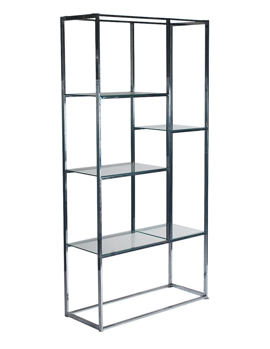 A classic asymmetrical design by Milo Baughman. This etagere features chrome framing with clear glass shelves. Very good well cared condition. 