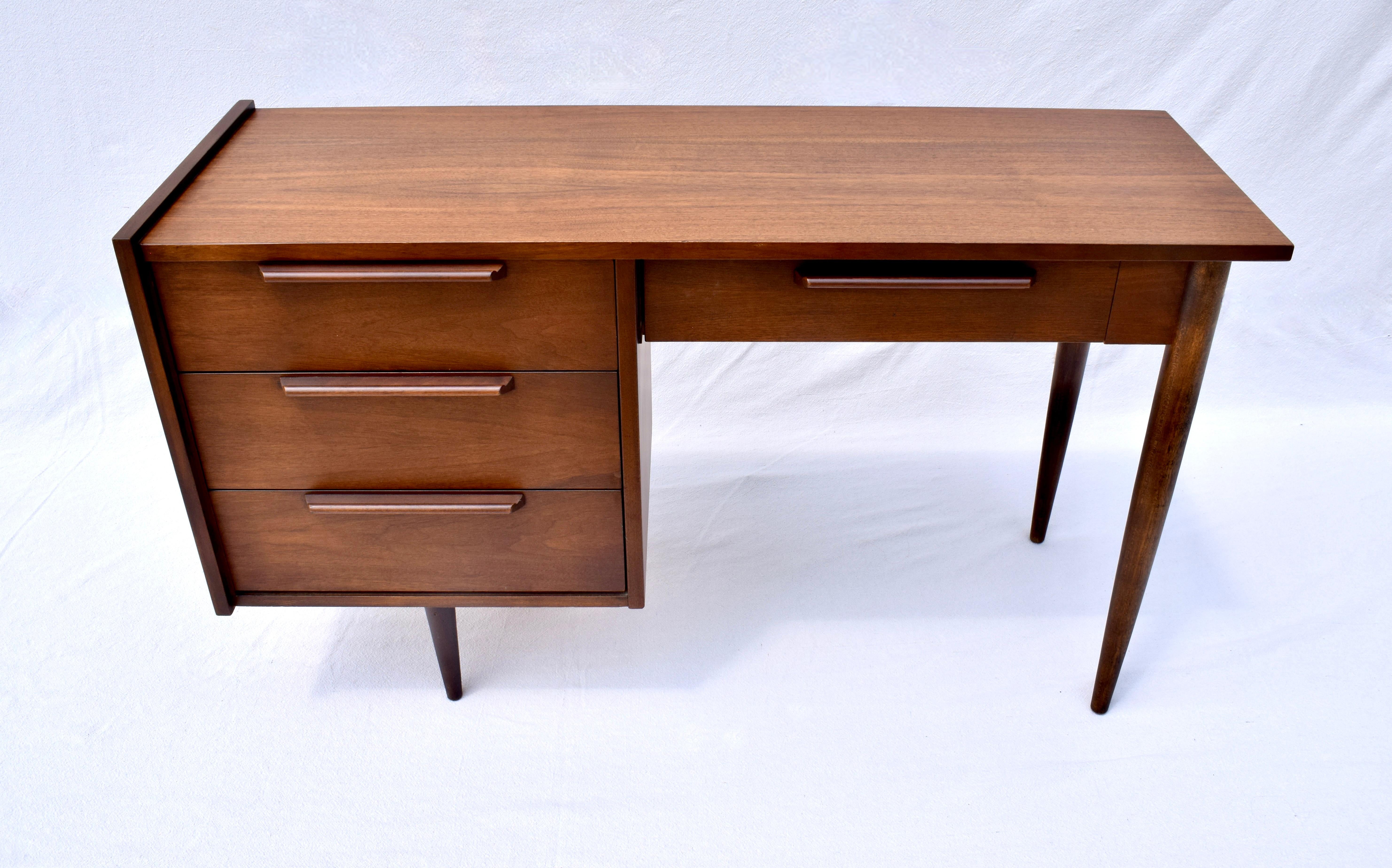 Mid Century Modern Walnut desk with four dovetail drawers & distinct Danish Modern Design elements throughout. Beautifully maintained solid structure with refinished top in excellent vintage condition. Attributed to Ben Thompson for Design Research.