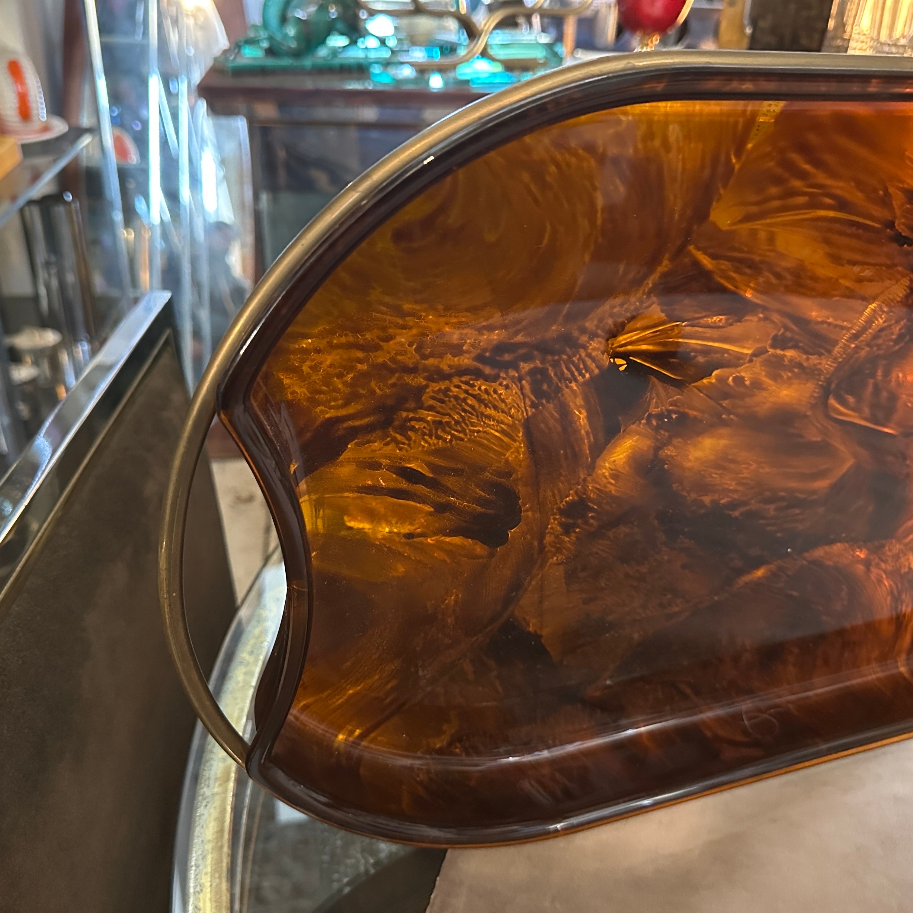 A Modernist Fake Tortoise Lucite and Brass vintage oval tray, designed and manufactured by the Italian design company Guzzini during the 1970s, it's in good condition. The Guzzini company is a well-known Italian brand that specializes in the