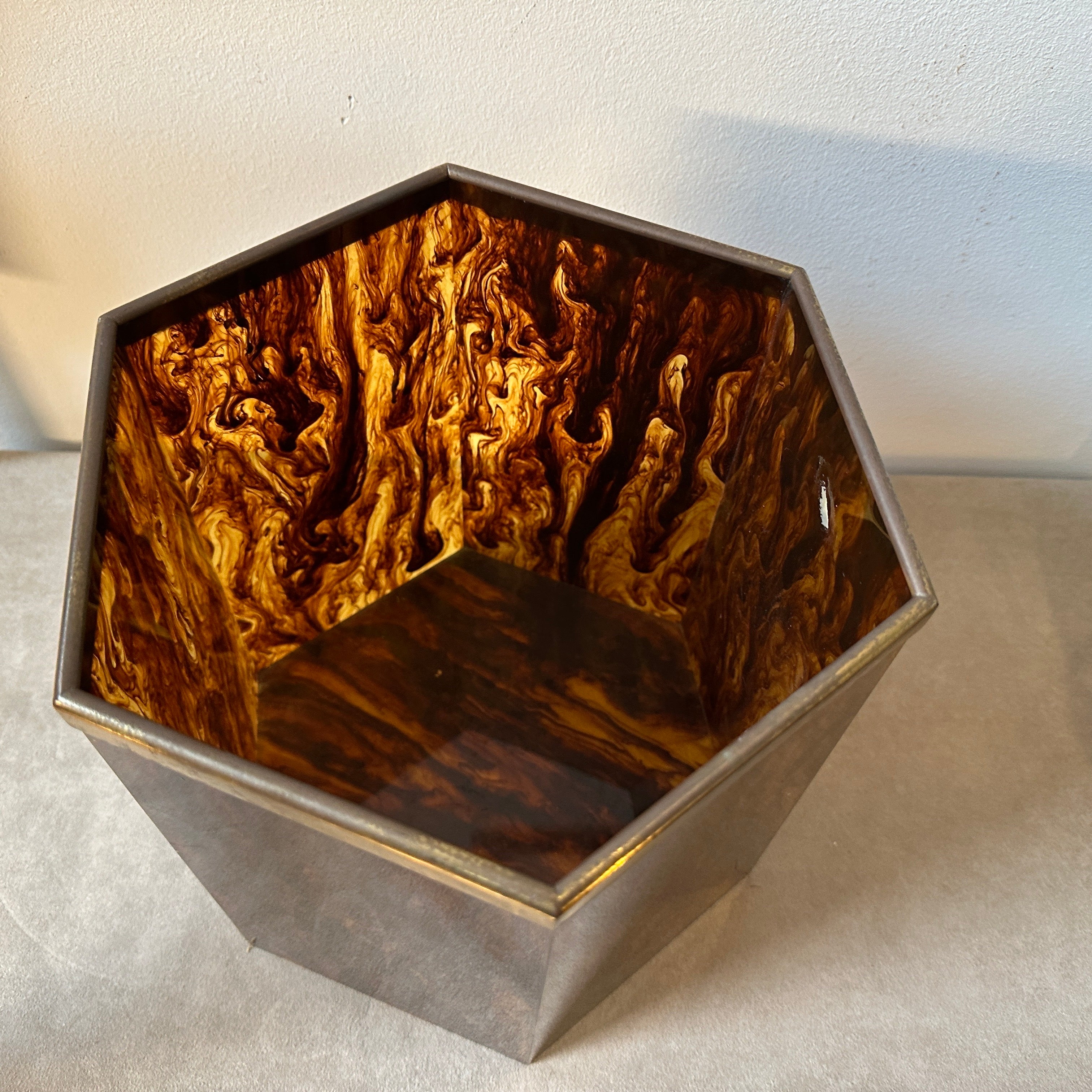 An hexagonal fake tortoise shell lucite and brass centerpiece designed and manufactured in Italy in the Seventies, it's in original conditions with small signs of use and age and brass in original patina. it was used as an amazing double wine
