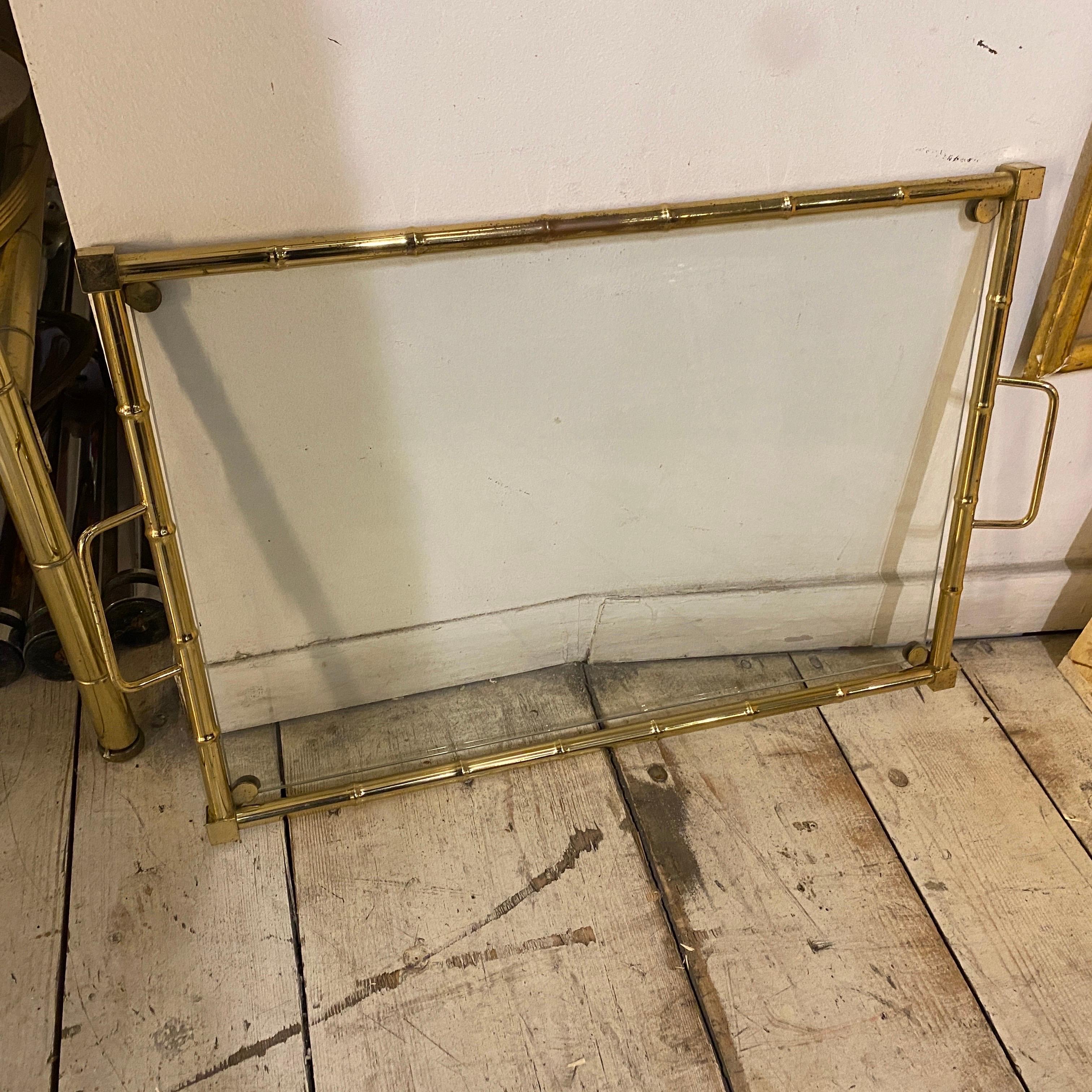 A rectangular fake bamboo brass and glass serving tray designed and manufactured in Italy in the Seventies, it's in good conditions overall. This Italian Serving Tray is a stylish and functional accessory that embodies the design ethos of its era