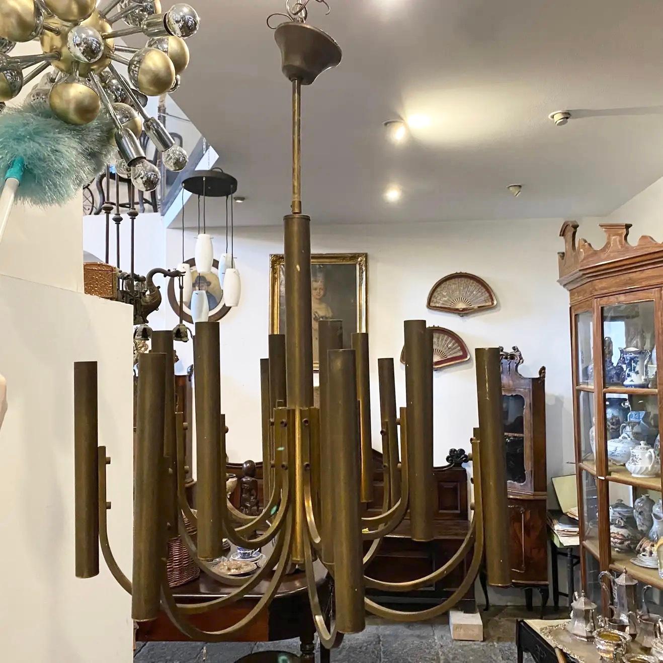 A brass Mid-Century Modern chandelier designed by Gaetano Sciolari and manufactured in Italy. It works both 110-240 volts and needs regular e14 bulbs, brass it's in original patina.