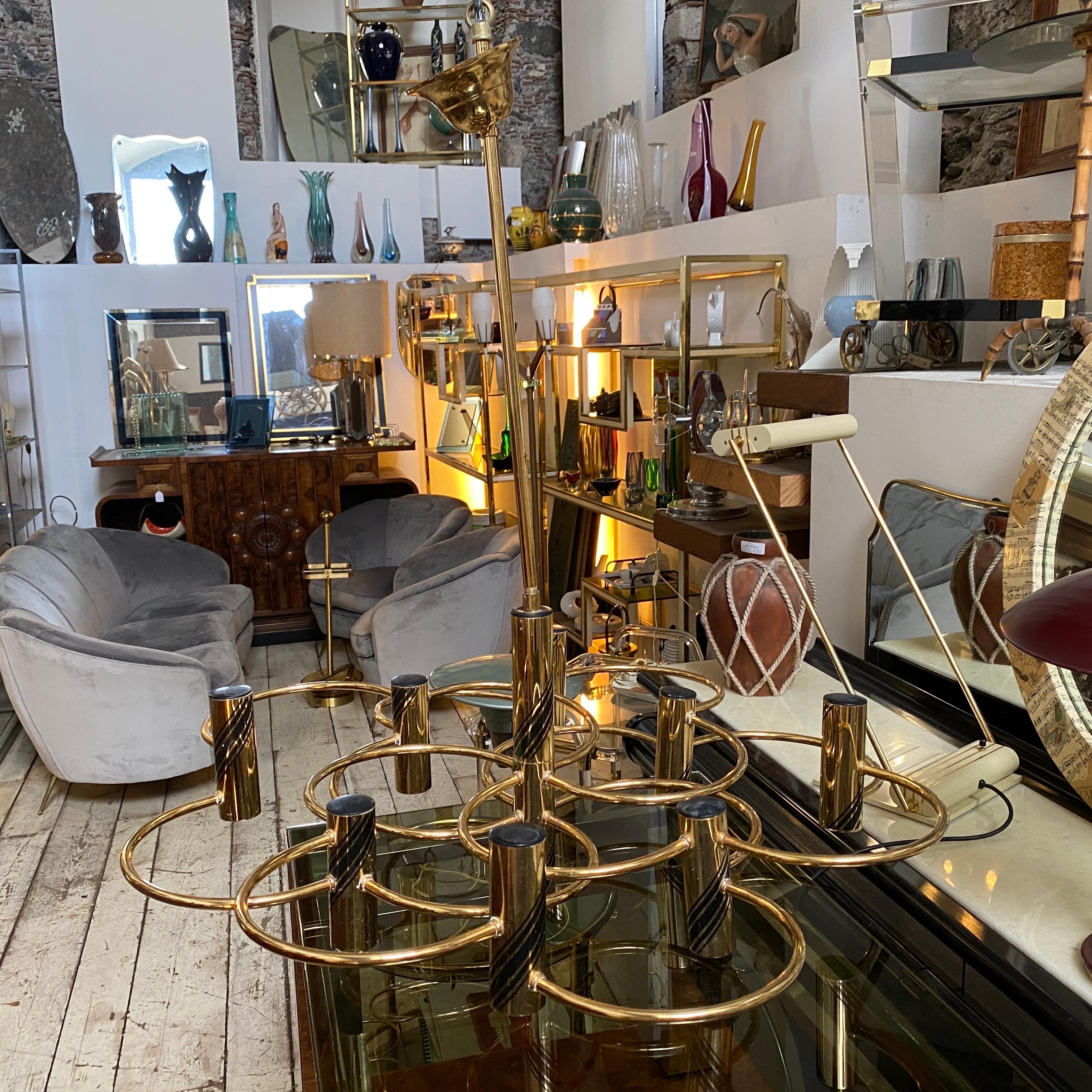 An iconic brass chandelier designed by Gaetano Sciolari in the Seventies. The chandelier it also can be used as a ceiling or wall light not using brass cilinder on the upper part. It's in perfect working order, it works both 110-240 volts and needs
