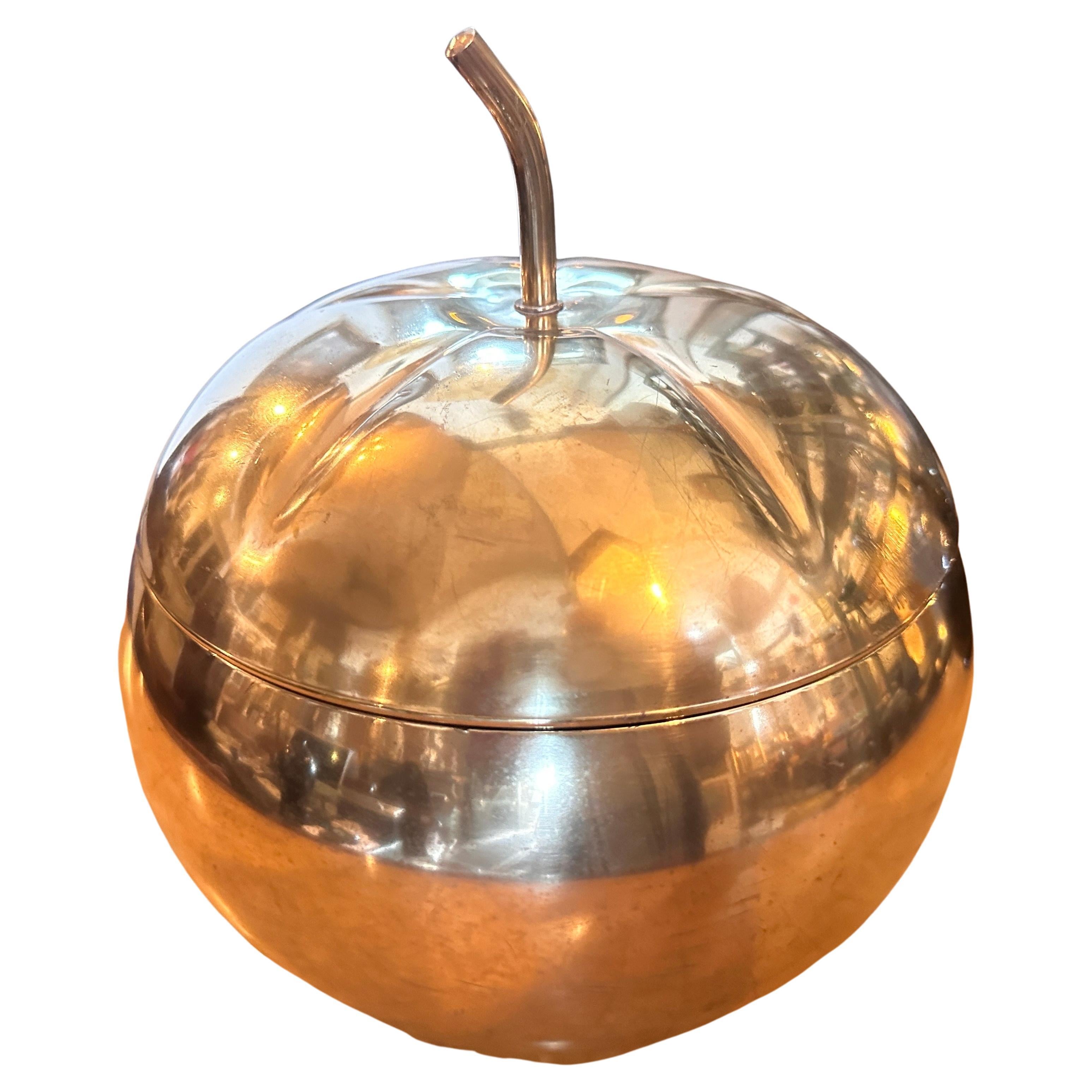 This 1970s Ice Bucket is a unique and stylish piece of functional decor that perfectly encapsulates the design sensibilities of the era. This ice bucket combines elements of Mid-Century Modern design with a touch of whimsy and playfulness. The ice