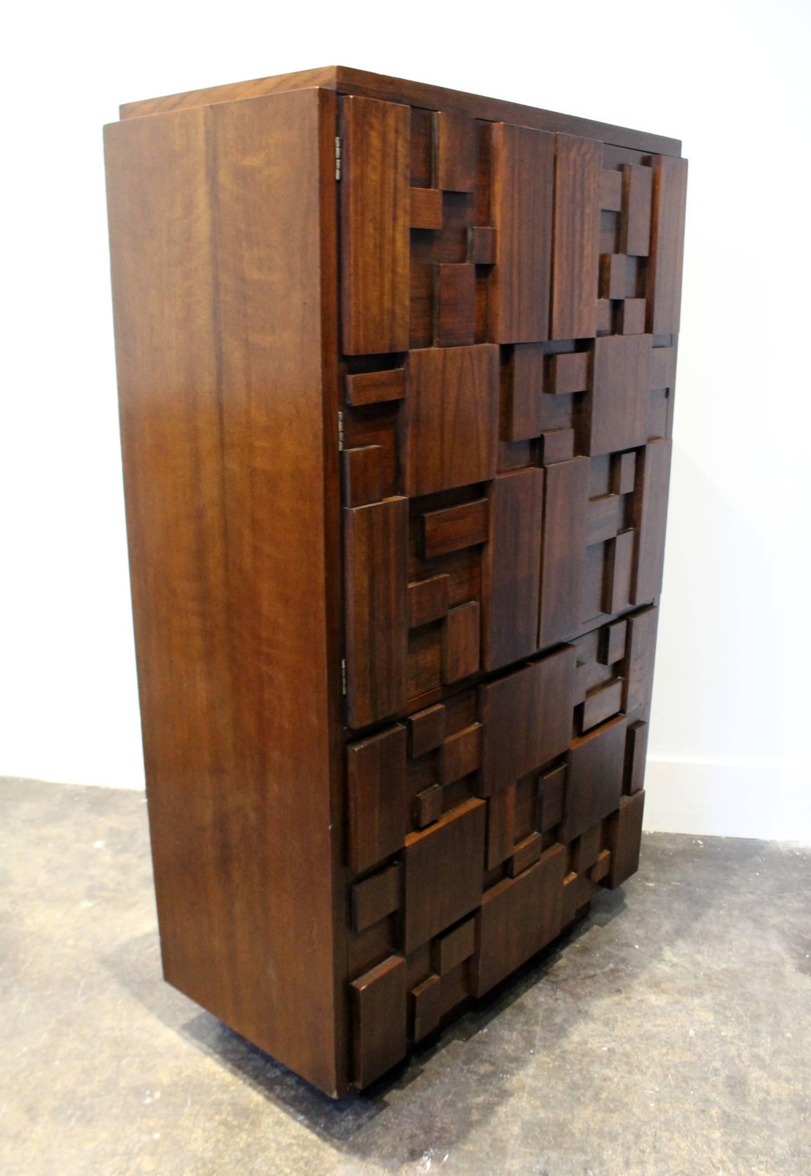 Lane Furniture's Classic 1970s, Brutalist tall chest. Intricate mosaic pattern across entire front. Three large drawers on the bottom. Top opens to reveal one more drawer and two shelves. Whole bedroom set is available.